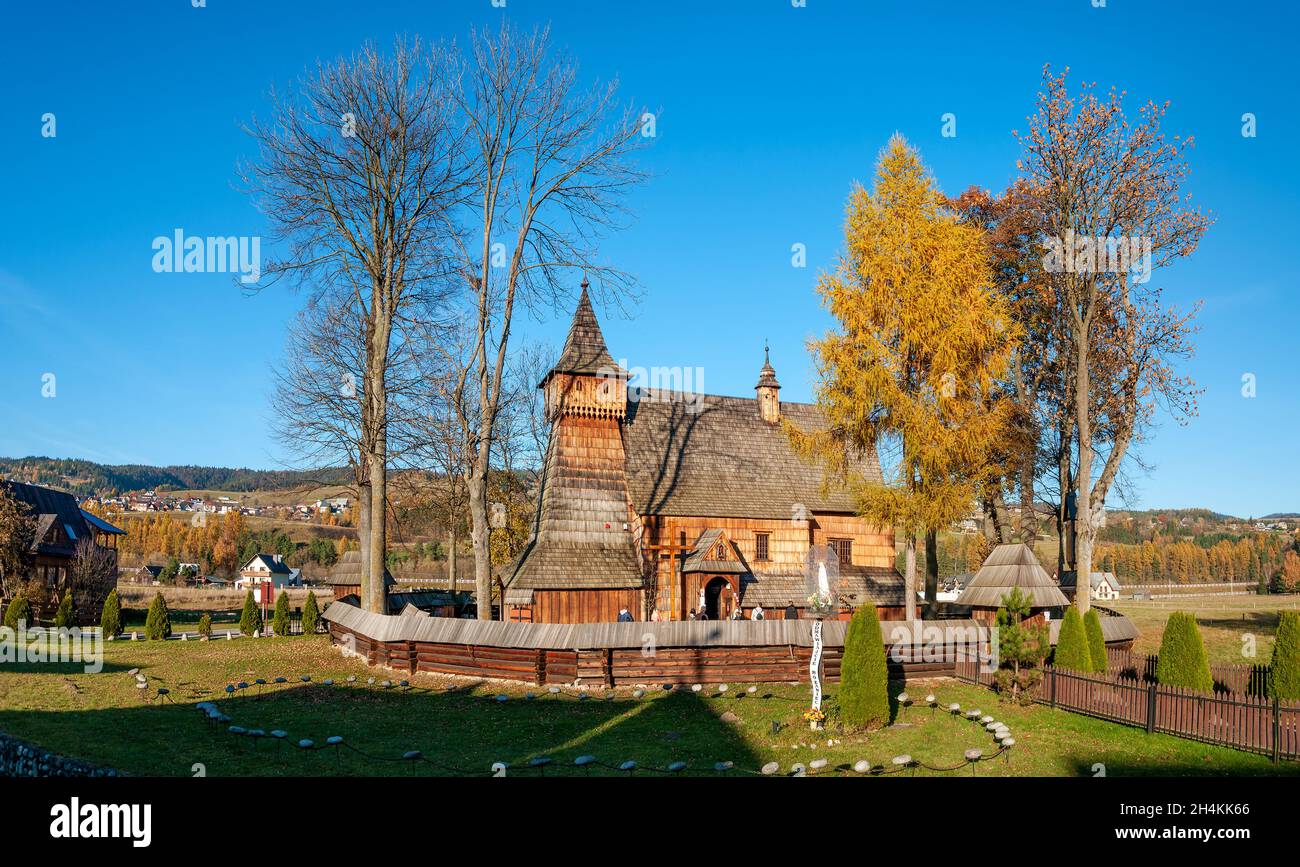 Old medieval Gothic wooden church of the Saint Archangel Michael in Debno, Poland. Autumn panorama. UNESCO World Heritage Site. Aerial photo. Stock Photo