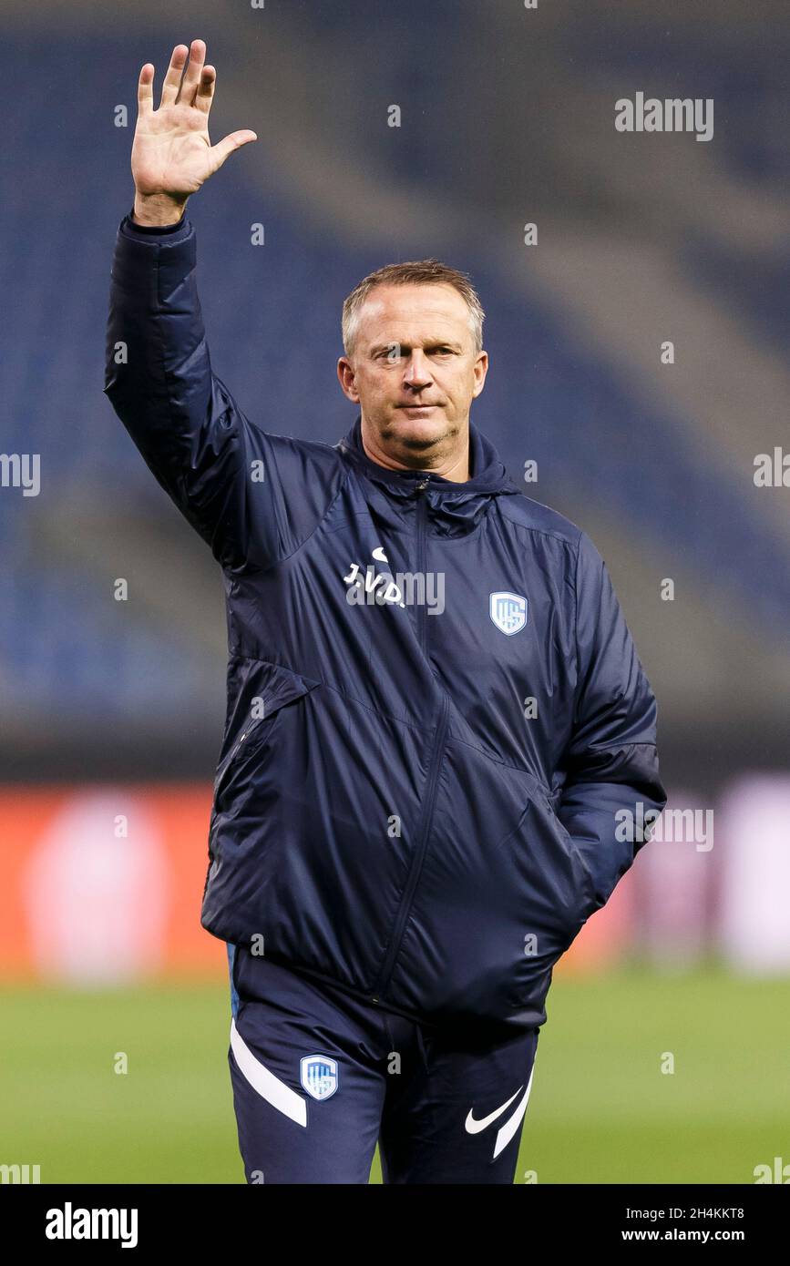 Genk, Belgium. 03rd Nov, 2021. KRC Genk Manager John van den Brom waves to the media during the stadium walkaround before their UEFA Europa League Group H match against West Ham United at Cegeka Arena on November 3rd 2021 in Genk, Belgium. (Photo by Daniel Chesterton/phcimages.com) Credit: PHC Images/Alamy Live News Stock Photo