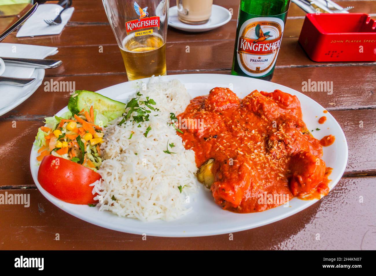BERLIN, GERMANY - AUGUST 12, 2017: Chicken vindaloo meal with Kingfisher beer. Stock Photo