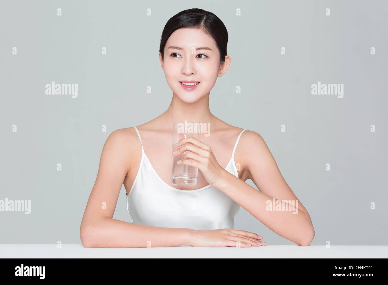 Beautiful young woman drinking water Stock Photo