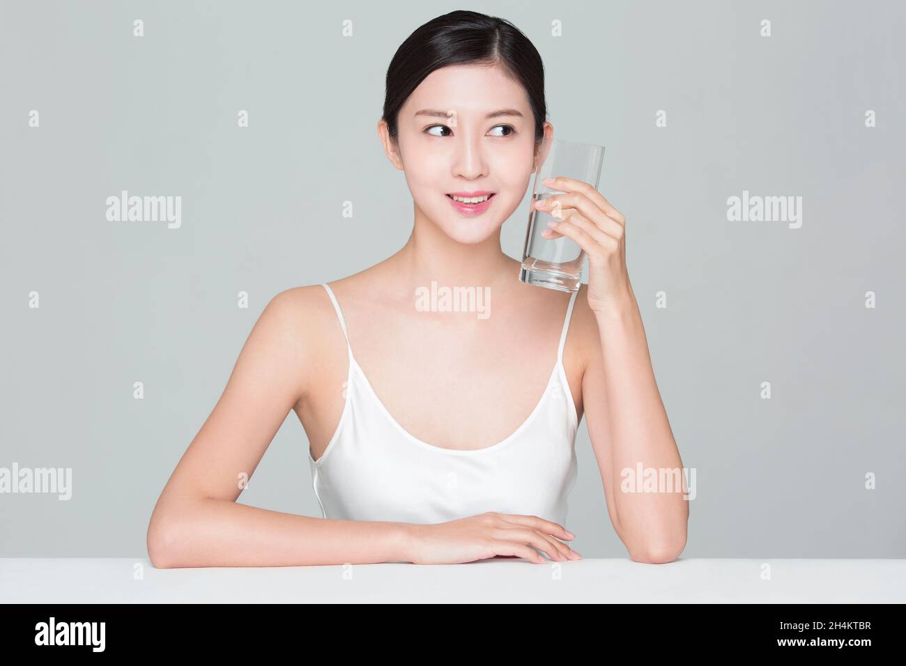 Beautiful young woman drinking water Stock Photo