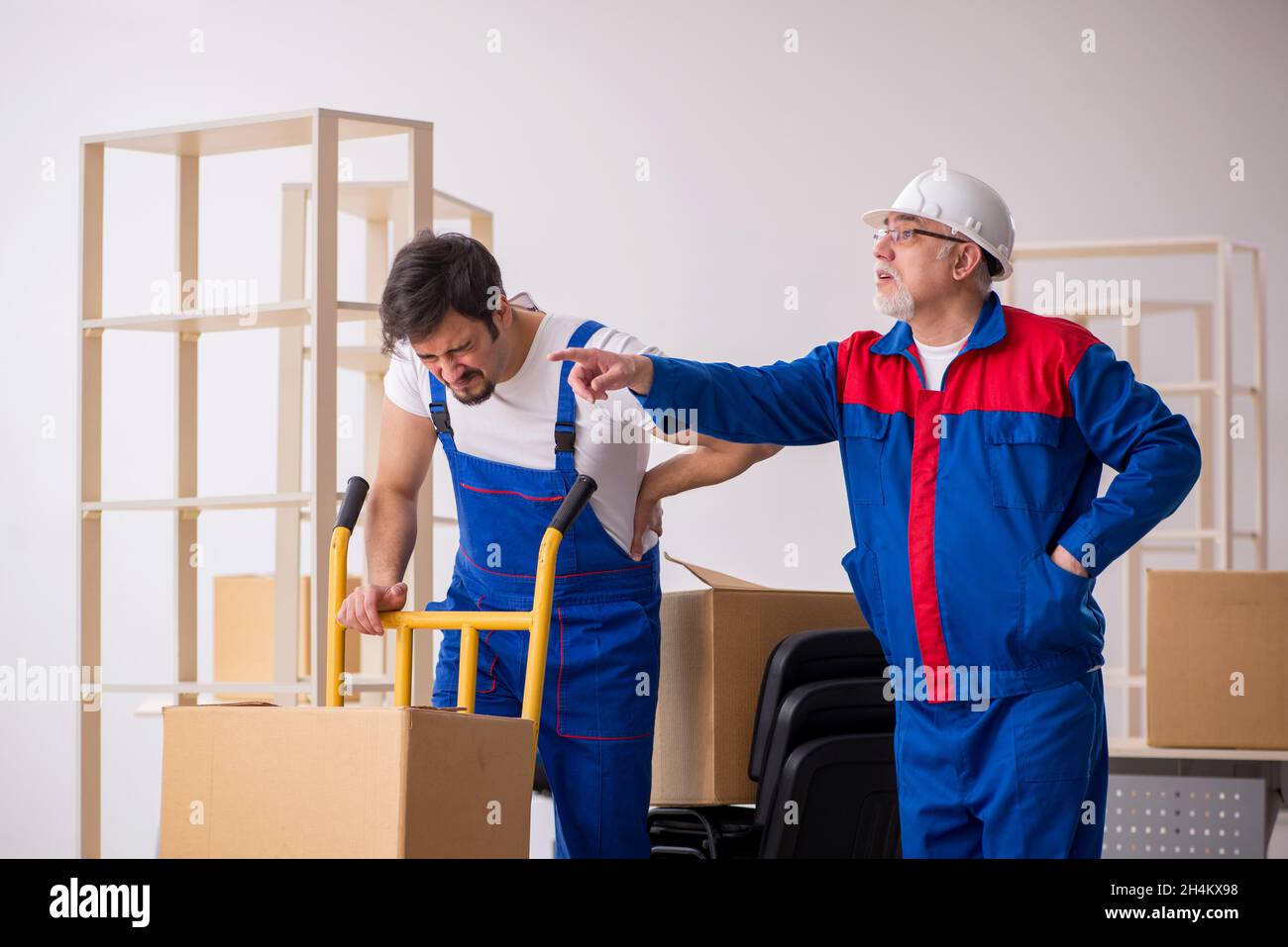 Two professional movers doing home relocation Stock Photo