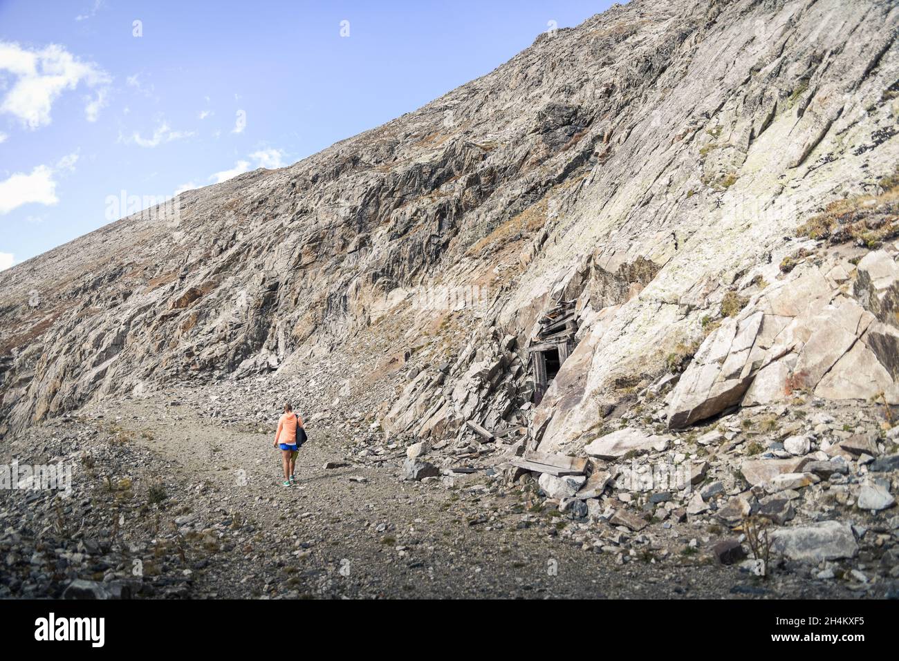 Woman walking on rocky road hi-res stock photography and images - Alamy