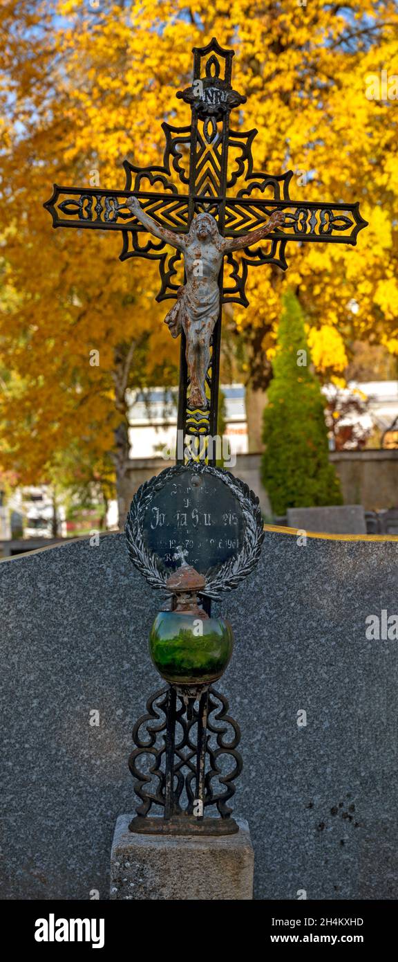 iron grave cross with christ and green bowl lamp, Austria Stock Photo