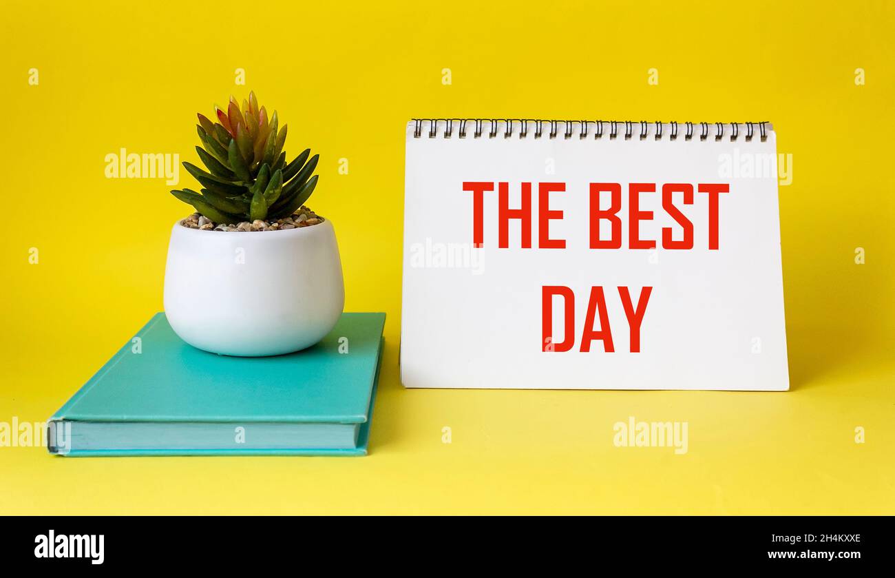 Best day text written on notepad and yellow background. Stock Photo