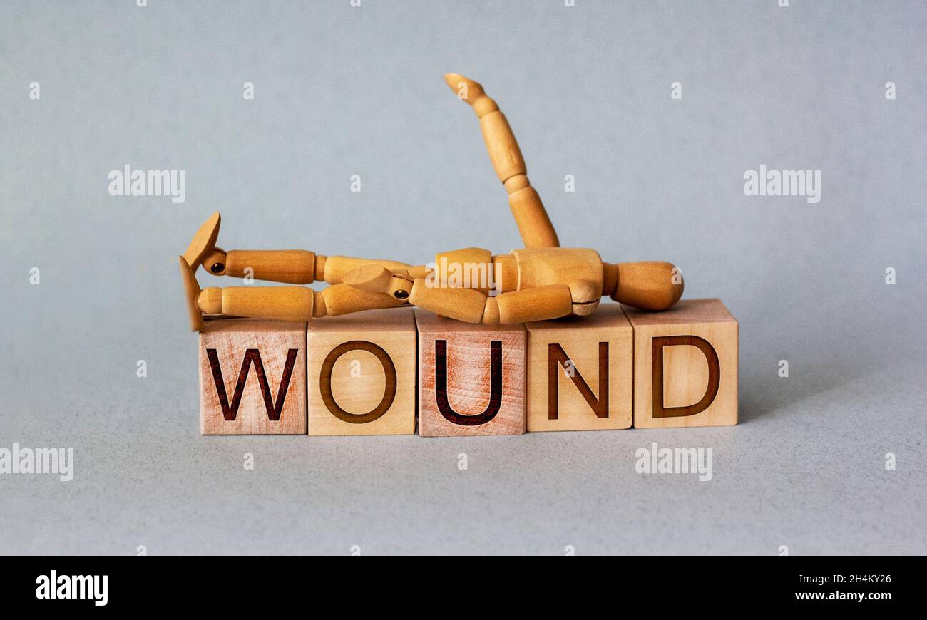 wound healing, word with cubes written in English and with wooden man