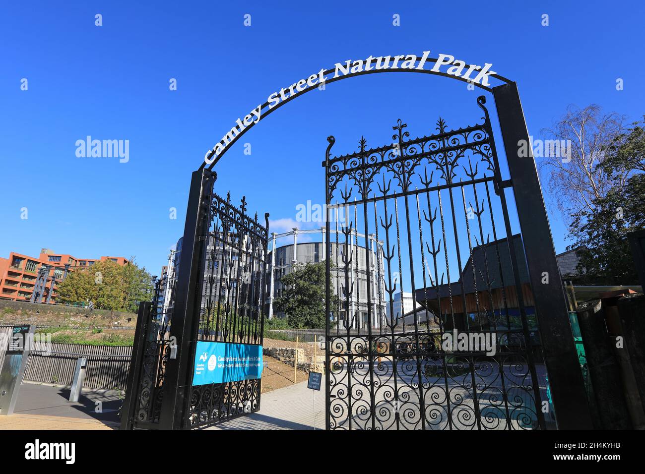 Entrance to the newly reopened Camley Street Natural Park, run by the London Wildlife Trust, with the Gasholders beyond, at Kings Cross, north London. Stock Photo