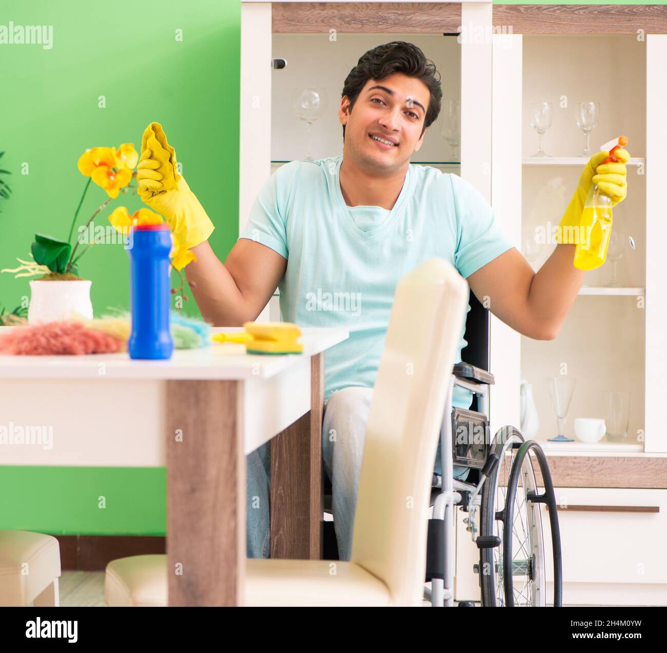 The disabled man on wheelchair cleaning house Stock Photo Alamy