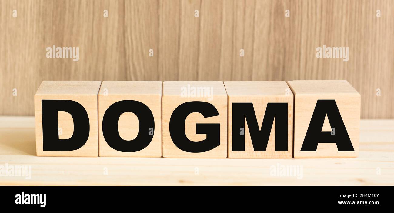 Word DOGMA on concept from wooden blocks on brown background Stock Photo