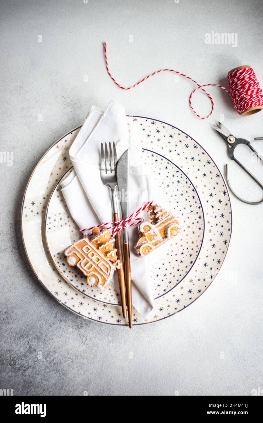 Minimalistic table setting for Christmas dinner on white concrete table Stock Photo