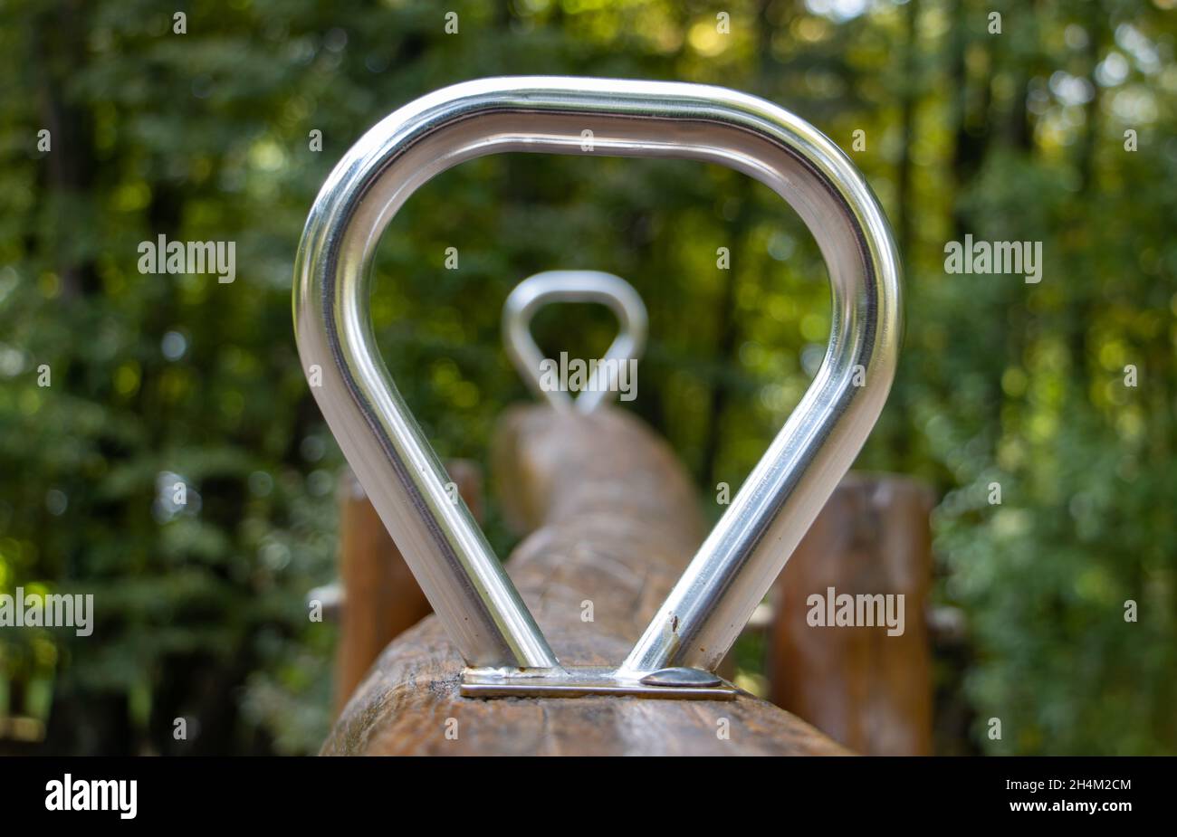 View through the handles of the swing, focused on the front handle Stock Photo