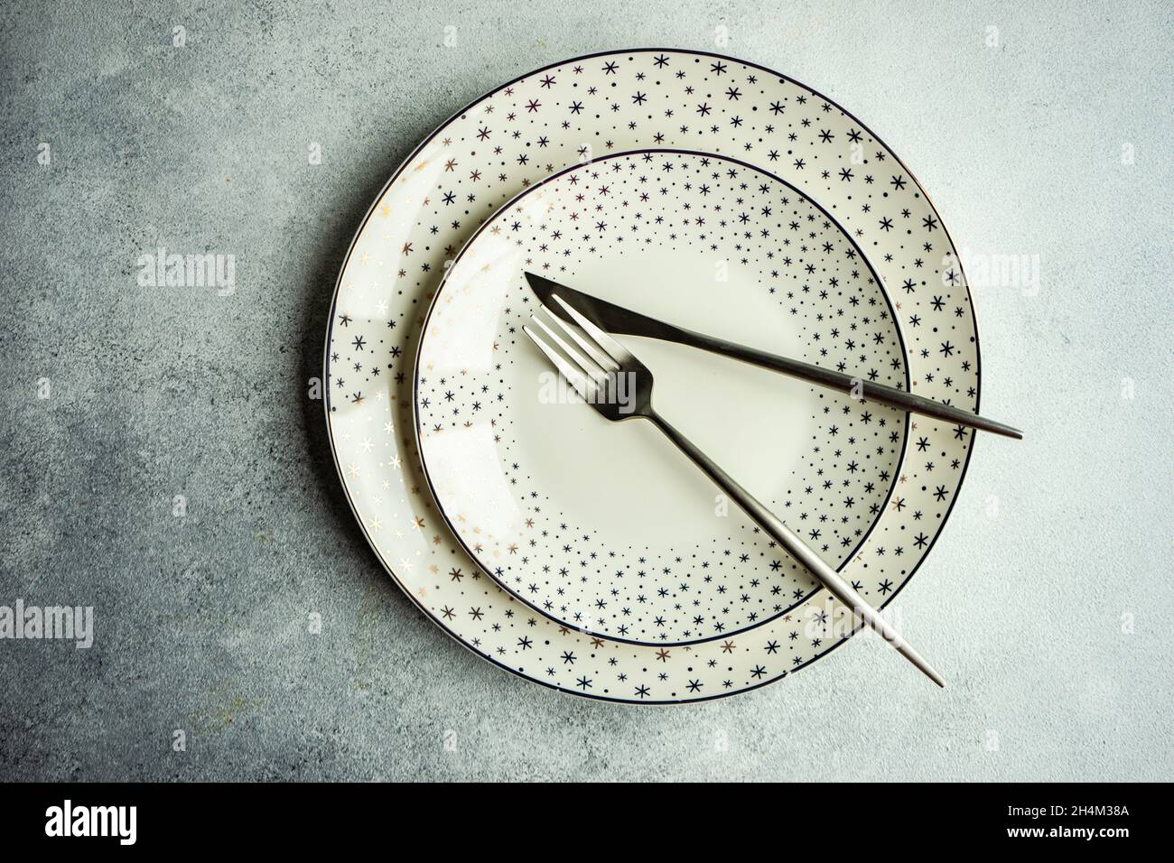 Minimalistic table setting for Christmas dinner on white concrete table Stock Photo