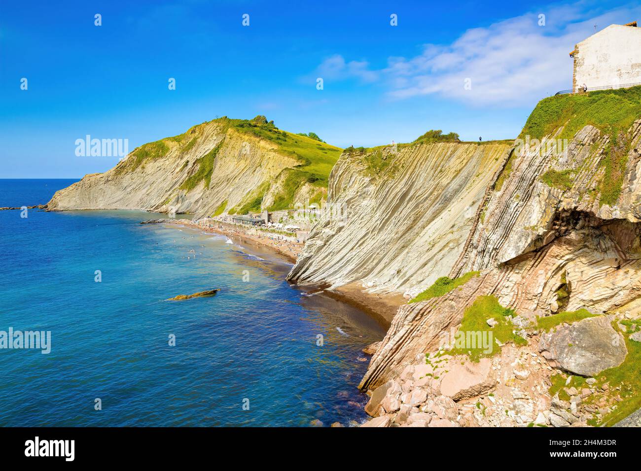 View of the cliff of Izurrun beach with its geological limestone rocks forming layers. Zumaya, Euskadi, Spain Stock Photo