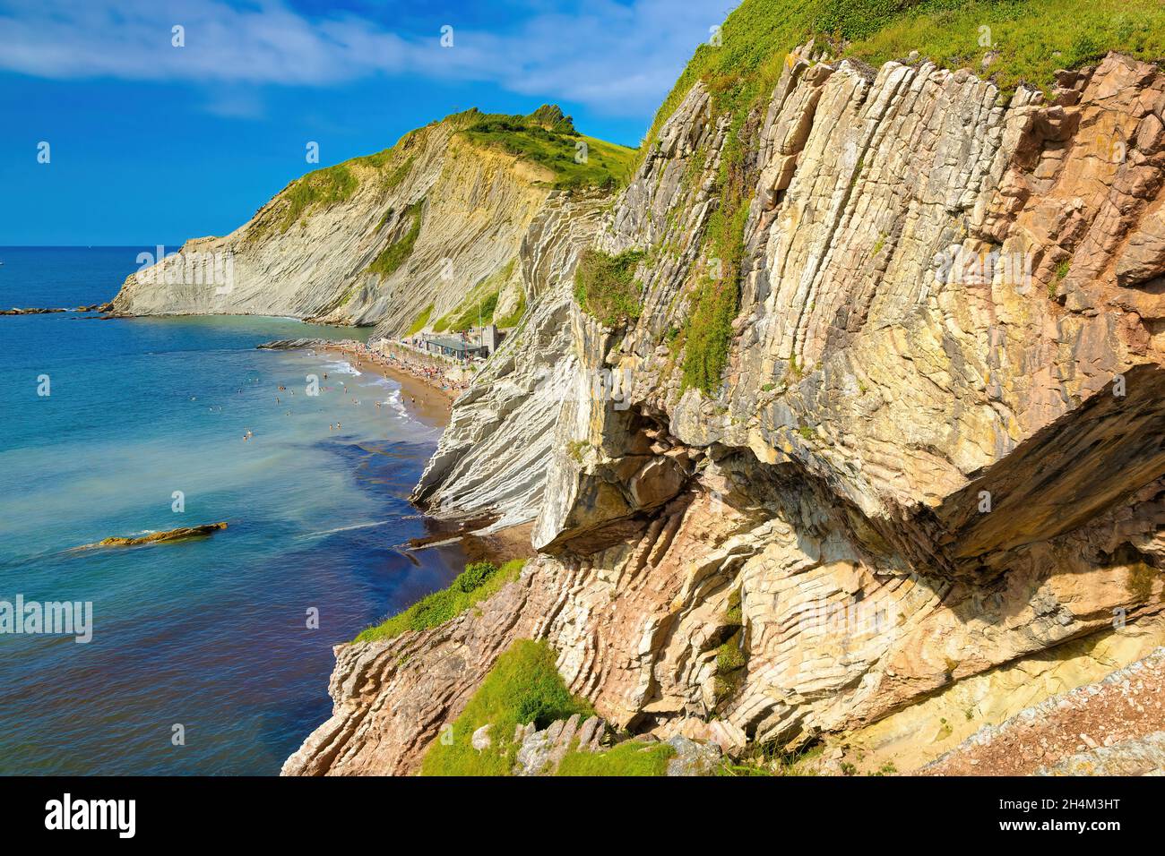 View of the cliff of Izurrun beach with its geological limestone rocks forming layers. Zumaya, Euskadi, Spain Stock Photo