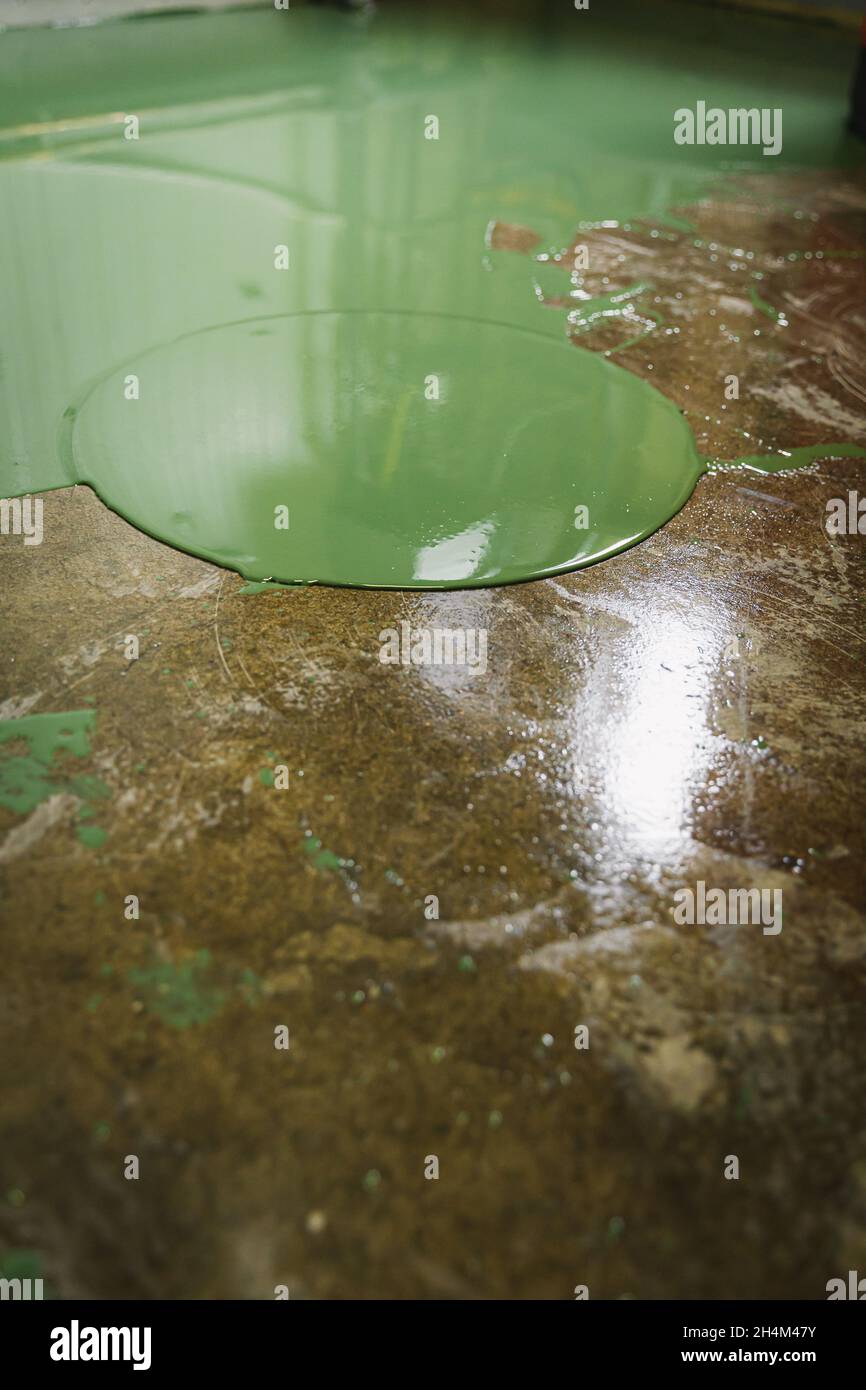 Floor under renovation with green epoxy resin applied over polished