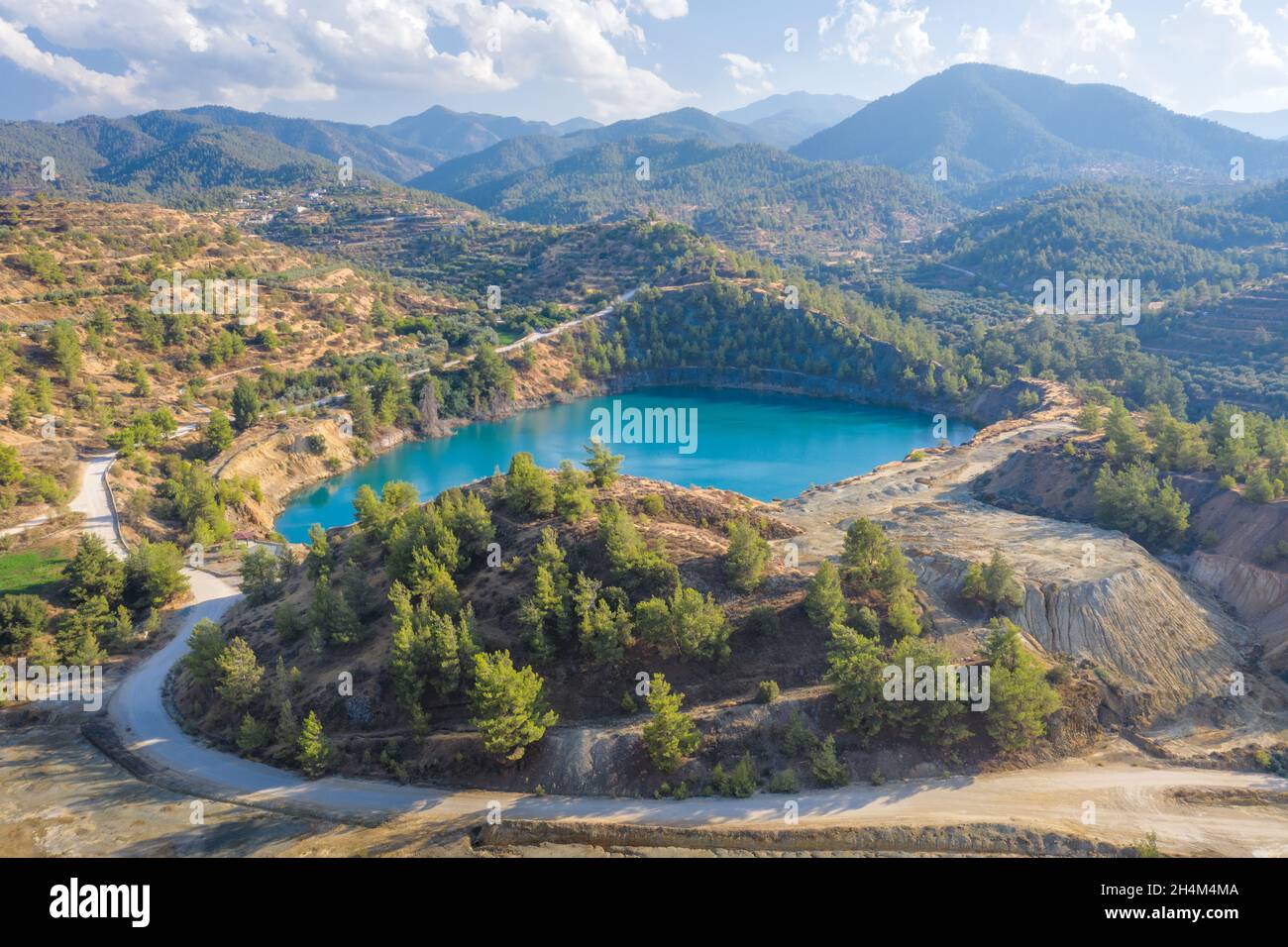 Memi lake in open pit of abandoned pyrite mine in Xyliatos, Cyprus. Ecological restoration and reforestation of old mining area Stock Photo