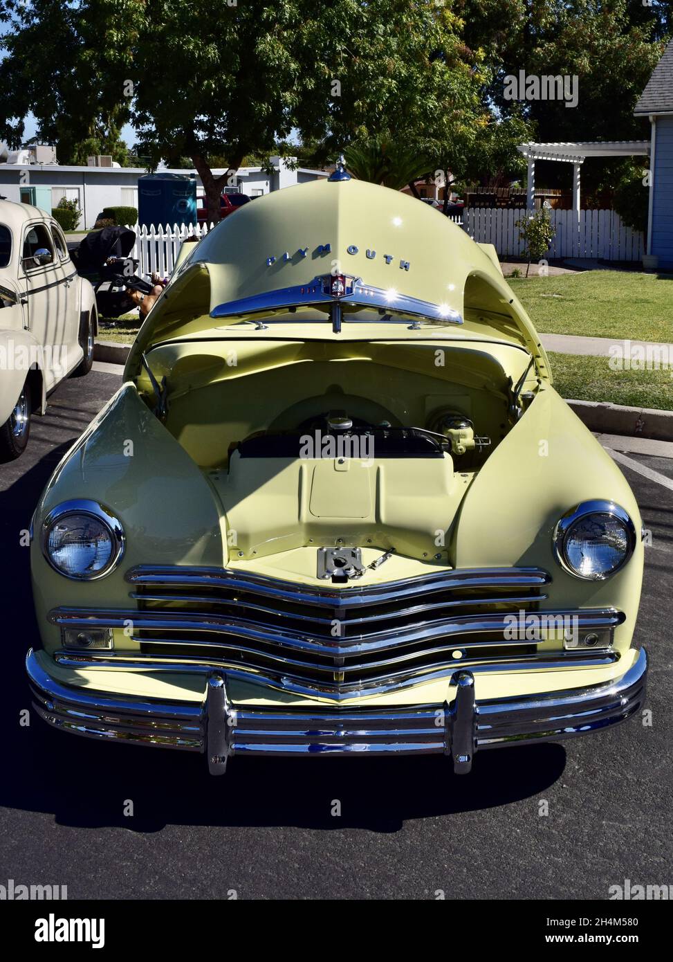FRESNO, UNITED STATES - Oct 09, 2021: A closeup of Classic 1949 Origin Special Yellow-colored Deluxe Plymouth Convertible Pale Stock Photo