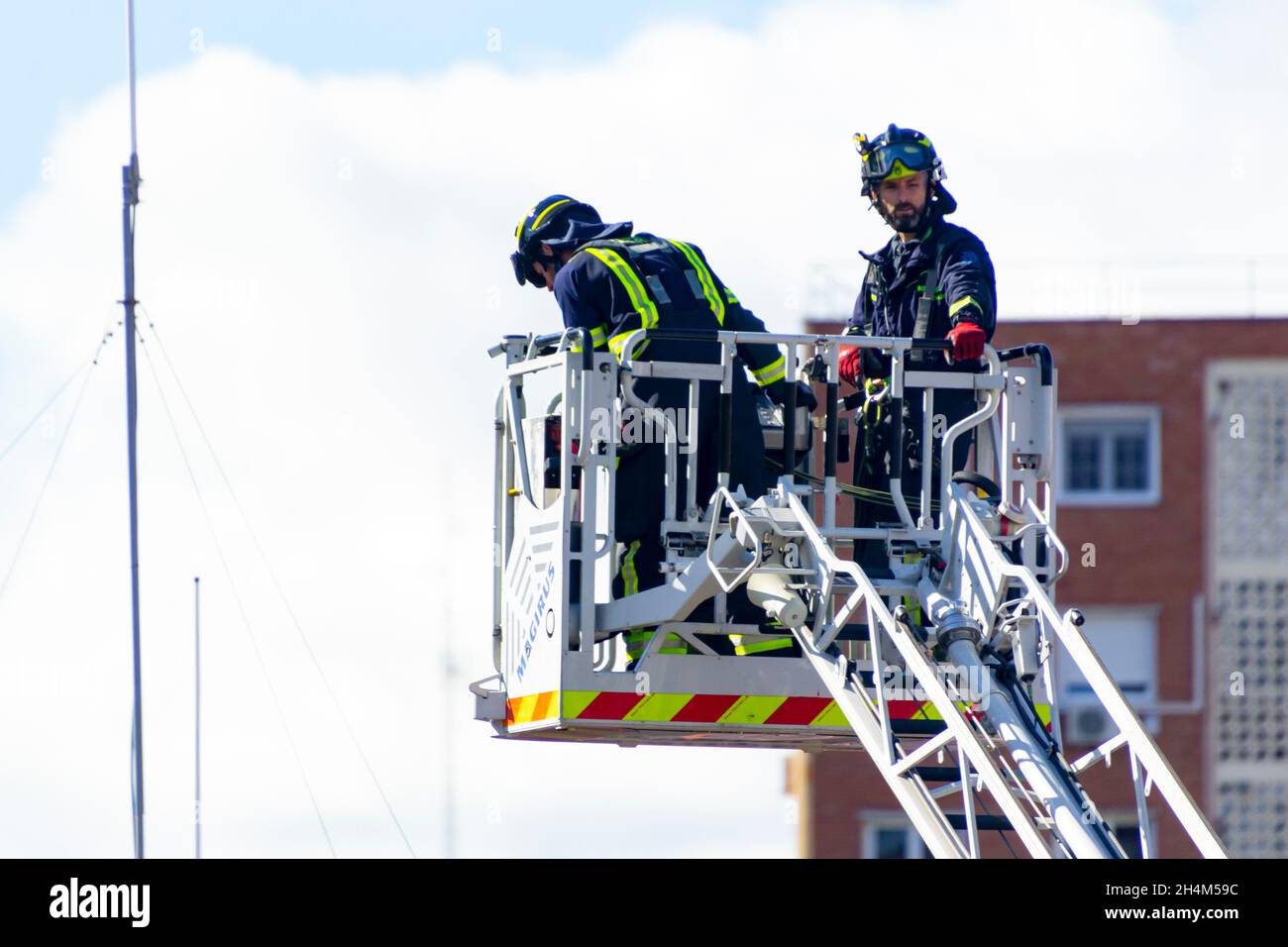 Firefighters climb a scale of a truck in one of the trainings in the fire station, in Madrid, Spain. Europe. Stock Photo