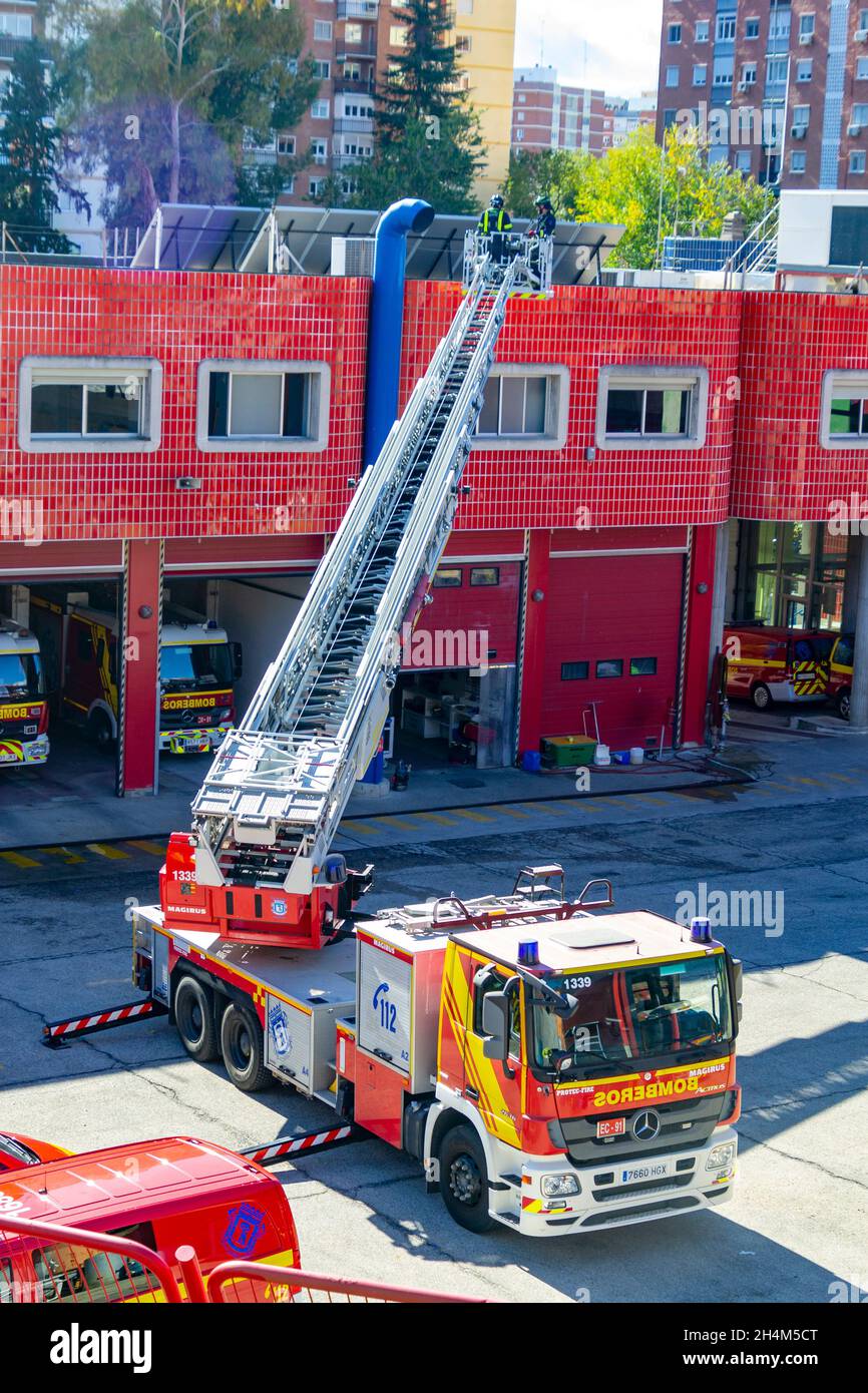 Firefighters climb a scale of a truck in one of the trainings in the fire station, in Madrid, Spain. Europe. Stock Photo