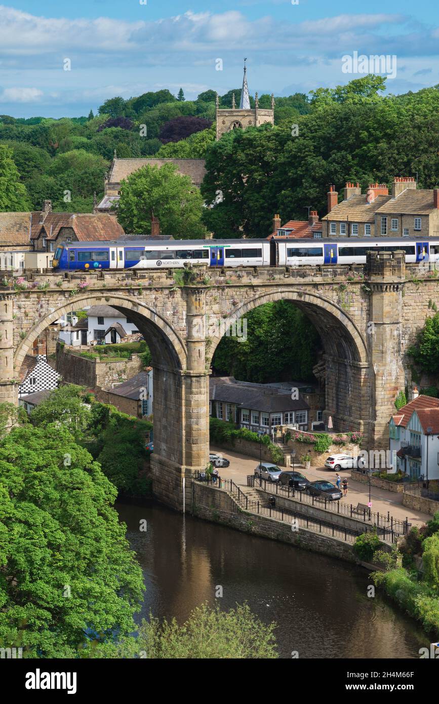 Knaresborough, view in summer of a train crossing the historic railway viaduct spanning the River Nidd in Knaresborough, North Yorkshire, England, UK Stock Photo