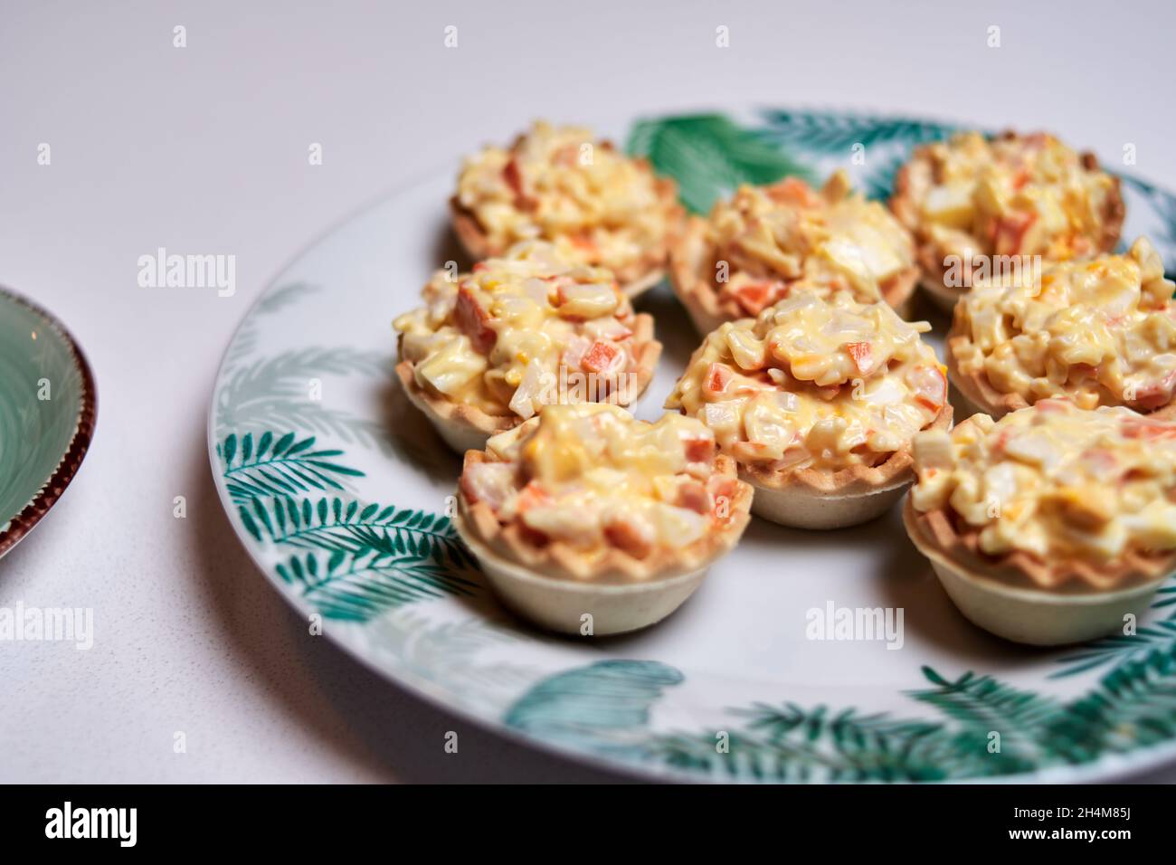 macrophotography of christmas canapes. crab stick tartlet with egg and