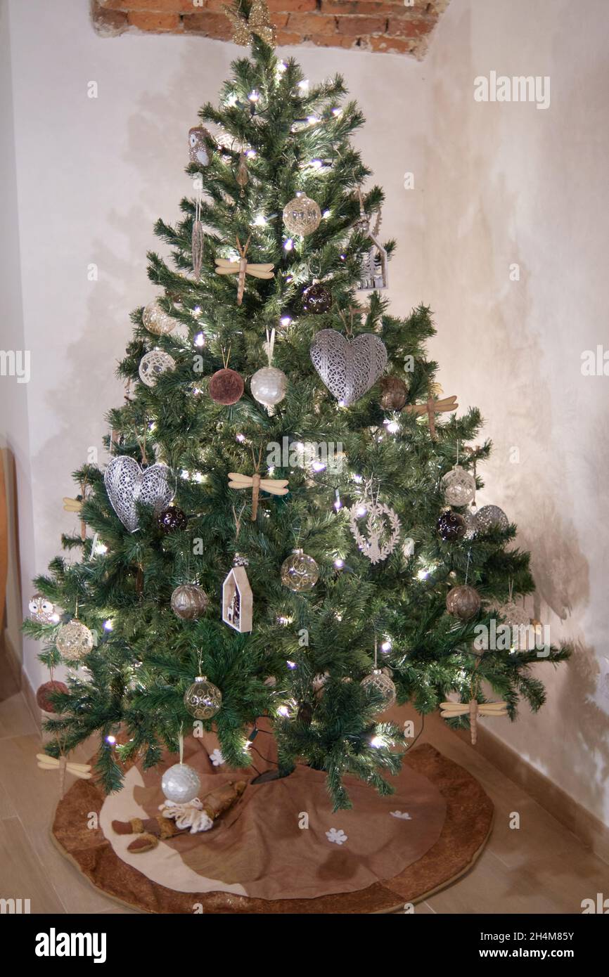 pretty christmas tree decorated with handmade ornaments and glowing lights. concept christmas and advent decoration Stock Photo