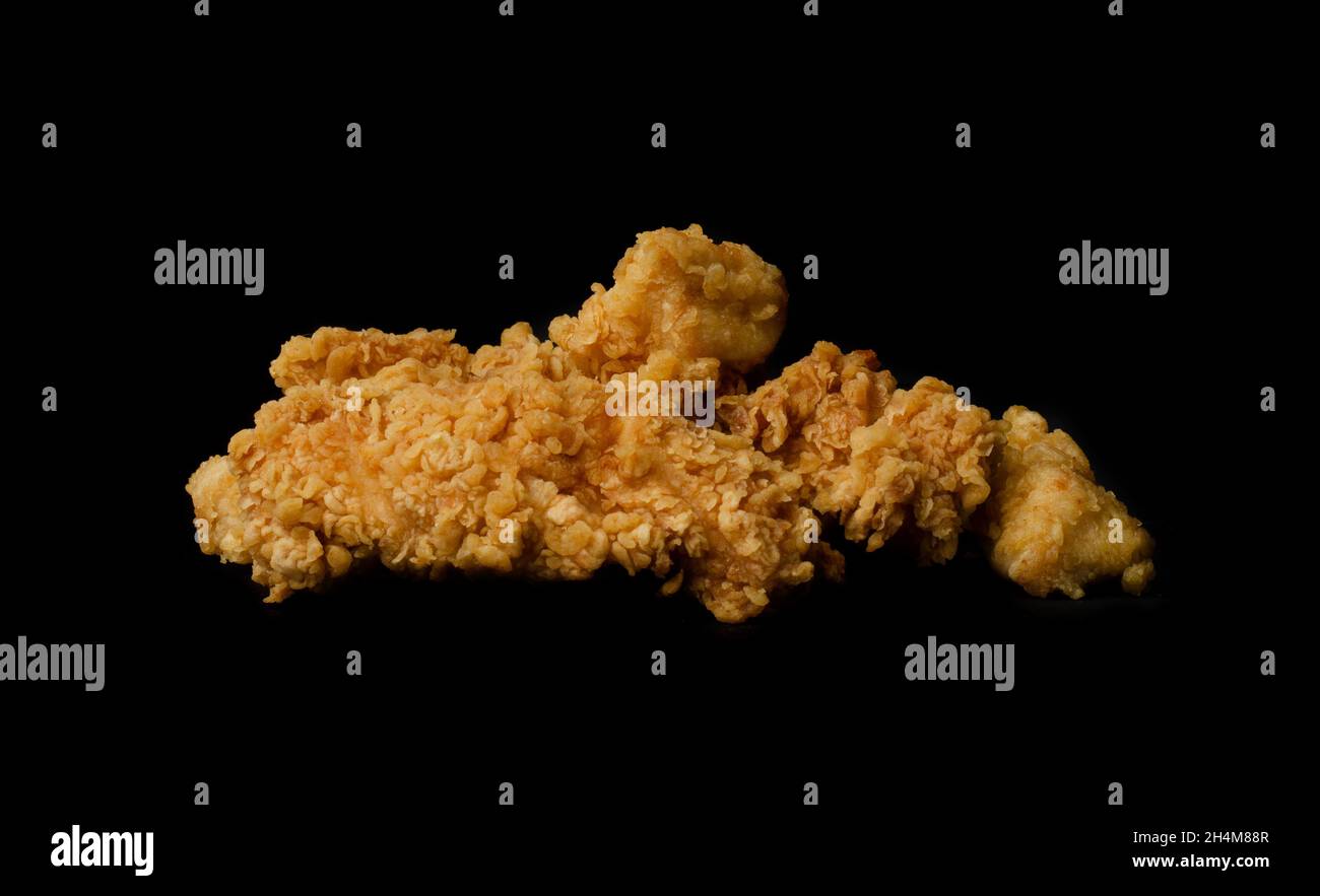 Chicken leg in breading on a black background Stock Photo