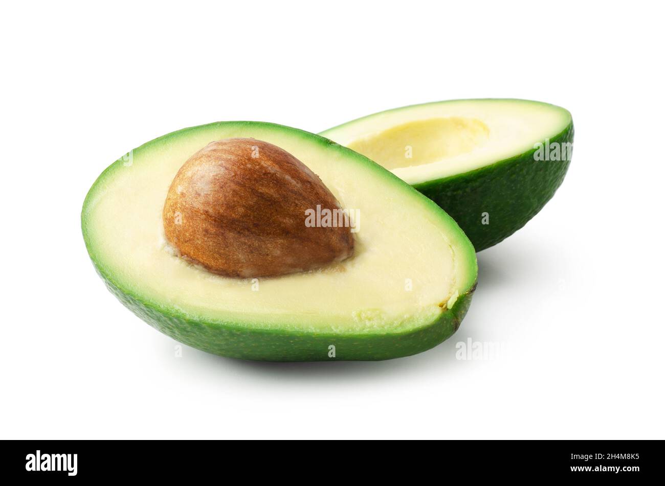 Avocado cut into halves isolated on white professional food photography Stock Photo