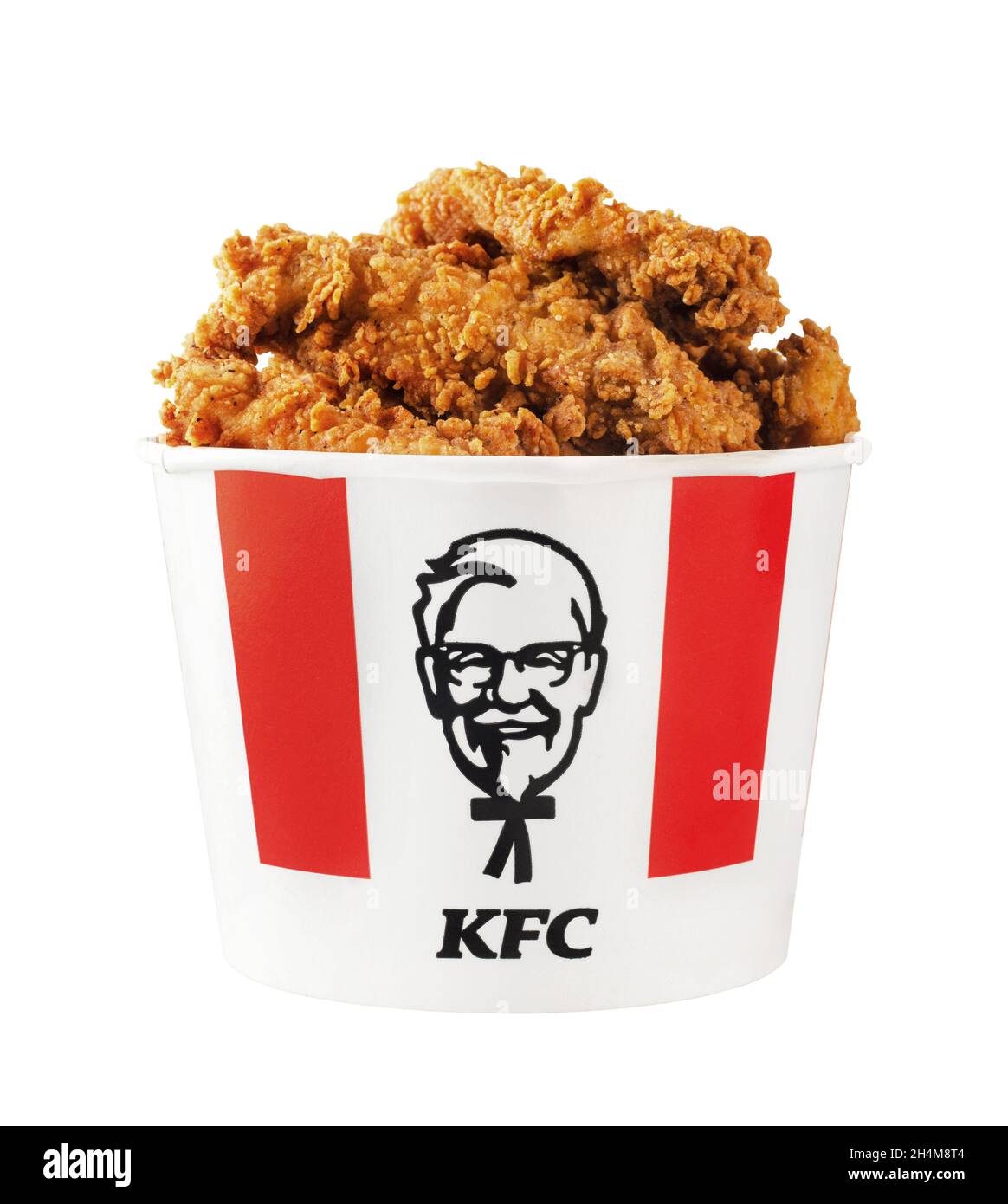 Moscow, Russia - July 9, 2020: A lots of KFC chicken hot wings or strips in bucket of KFC (Kentucky Fried Chicken) fast food. Isolated on a white back Stock Photo