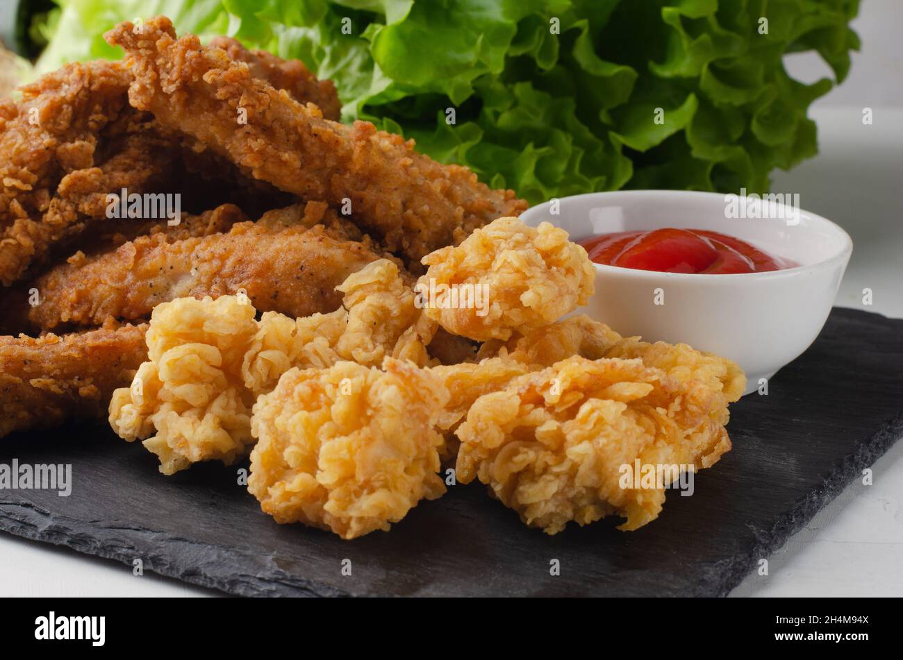 Fried chicken with french fries and nuggets. With ketchup. Stock Photo