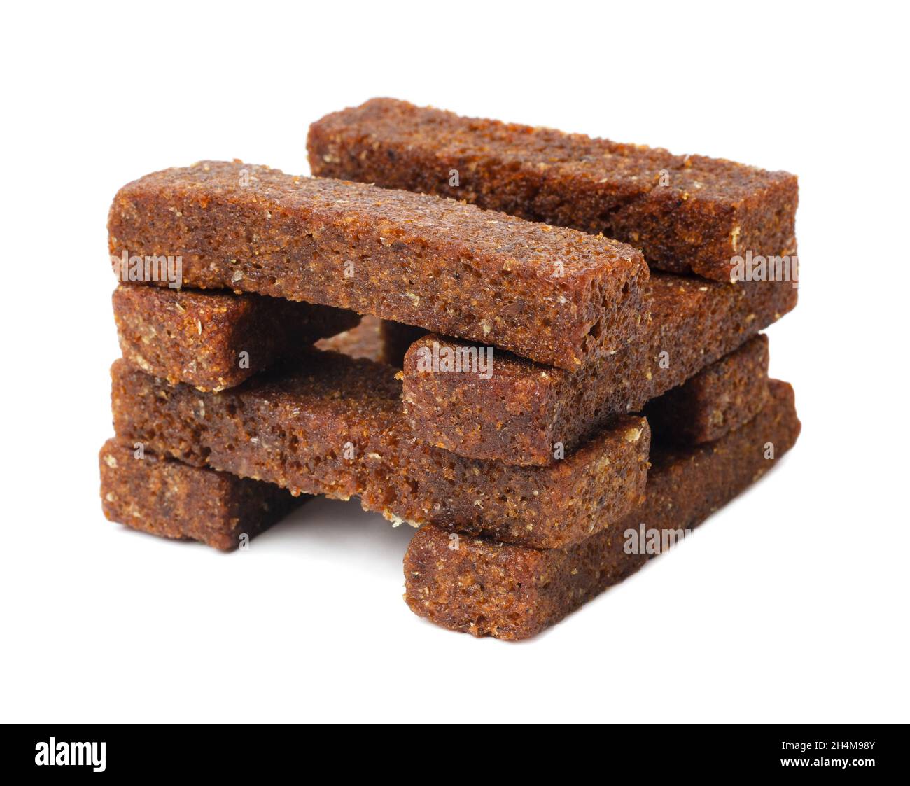 Toast bread crumbs isolated on white background. A piece of brown bread. Crumbs of bread croutons. Stock Photo