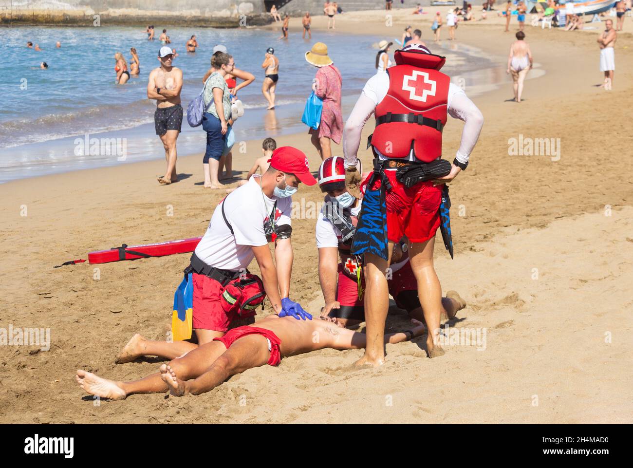 Red Cross lifeguards rescue simulation and CPR on beach in Spain Stock ...