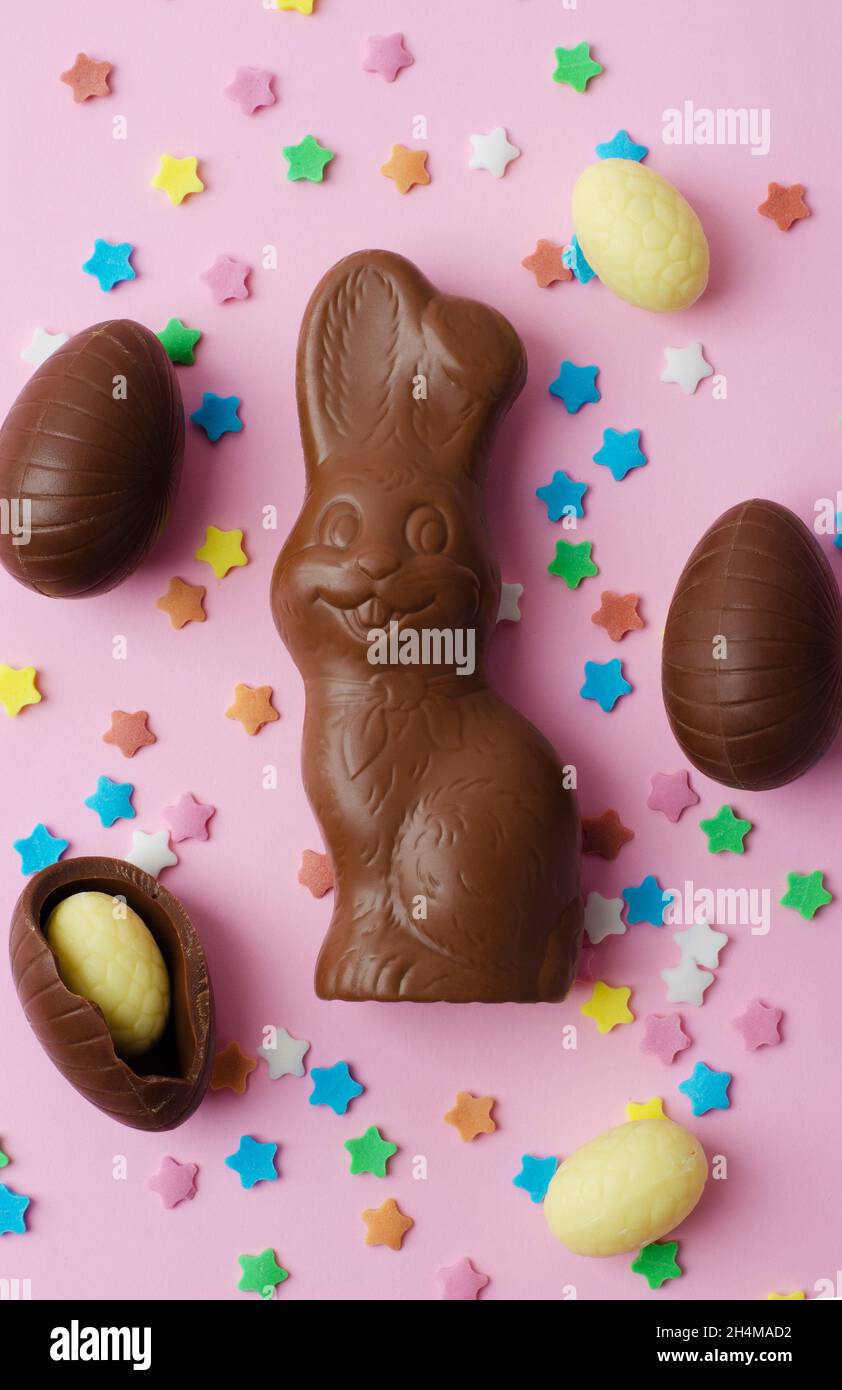 Easter chocolate bunny and eggs on a pink background Stock Photo - Alamy