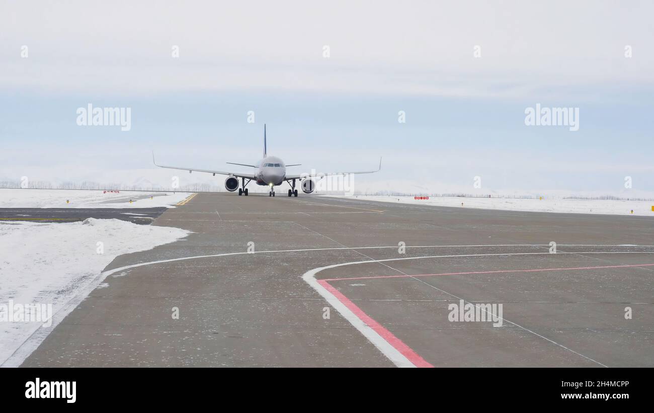 Plane rides on runway. Stock footage. Plane is preparing for takeoff moving  along runway in winter. Plane on runway before flying abroad for vacation  Stock Photo - Alamy