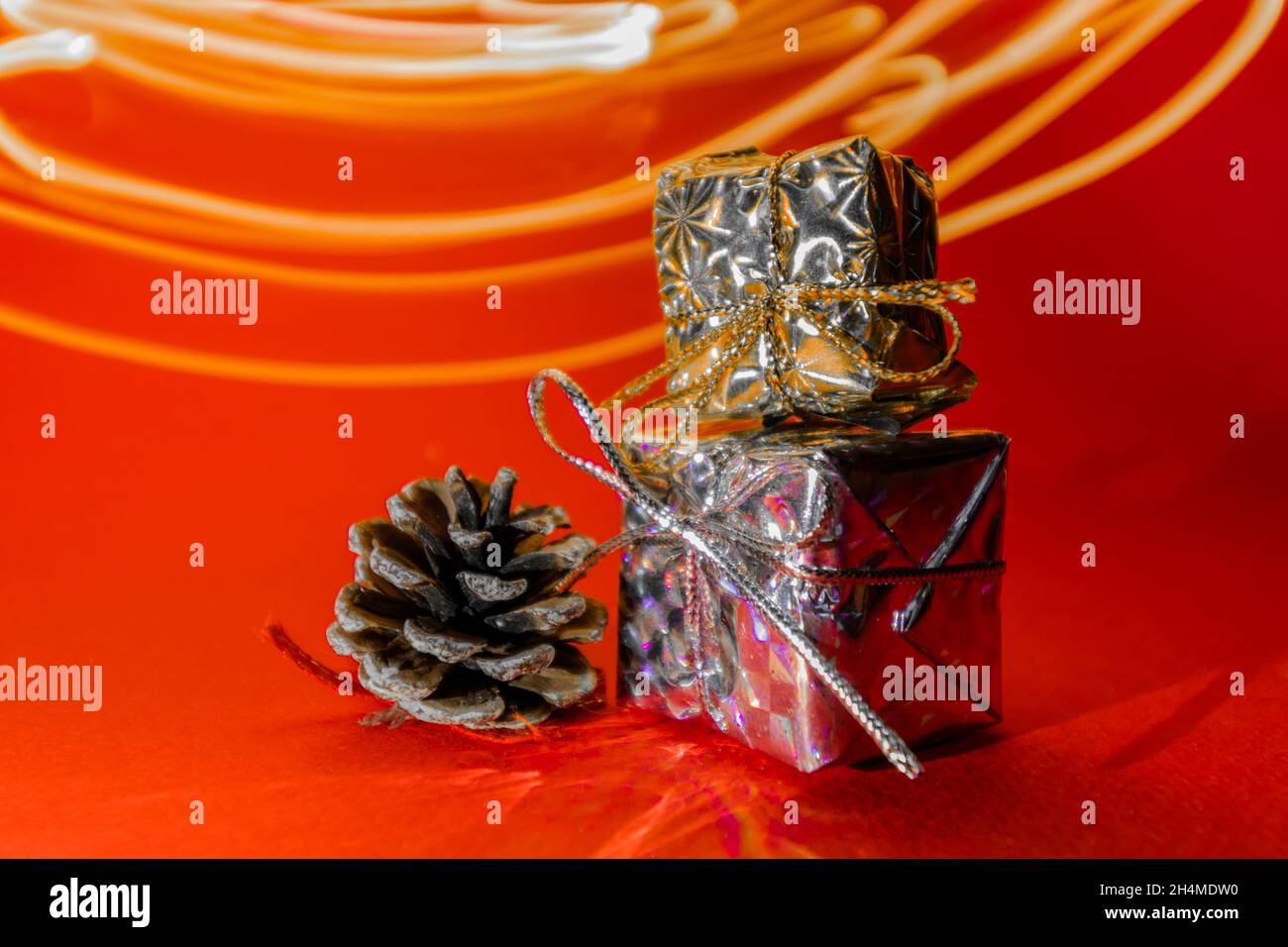 Two small gifts on a red background. Gifts in honor of the new year. Stock Photo