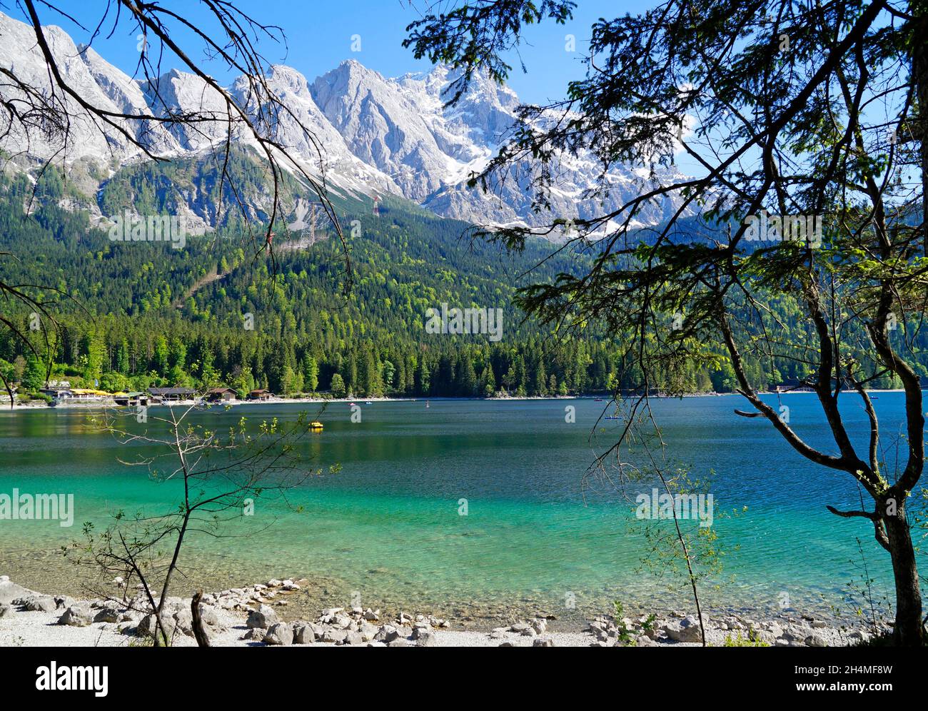 picturesque turquoise lake Eibsee by the foot of mountain Zugspitze in ...