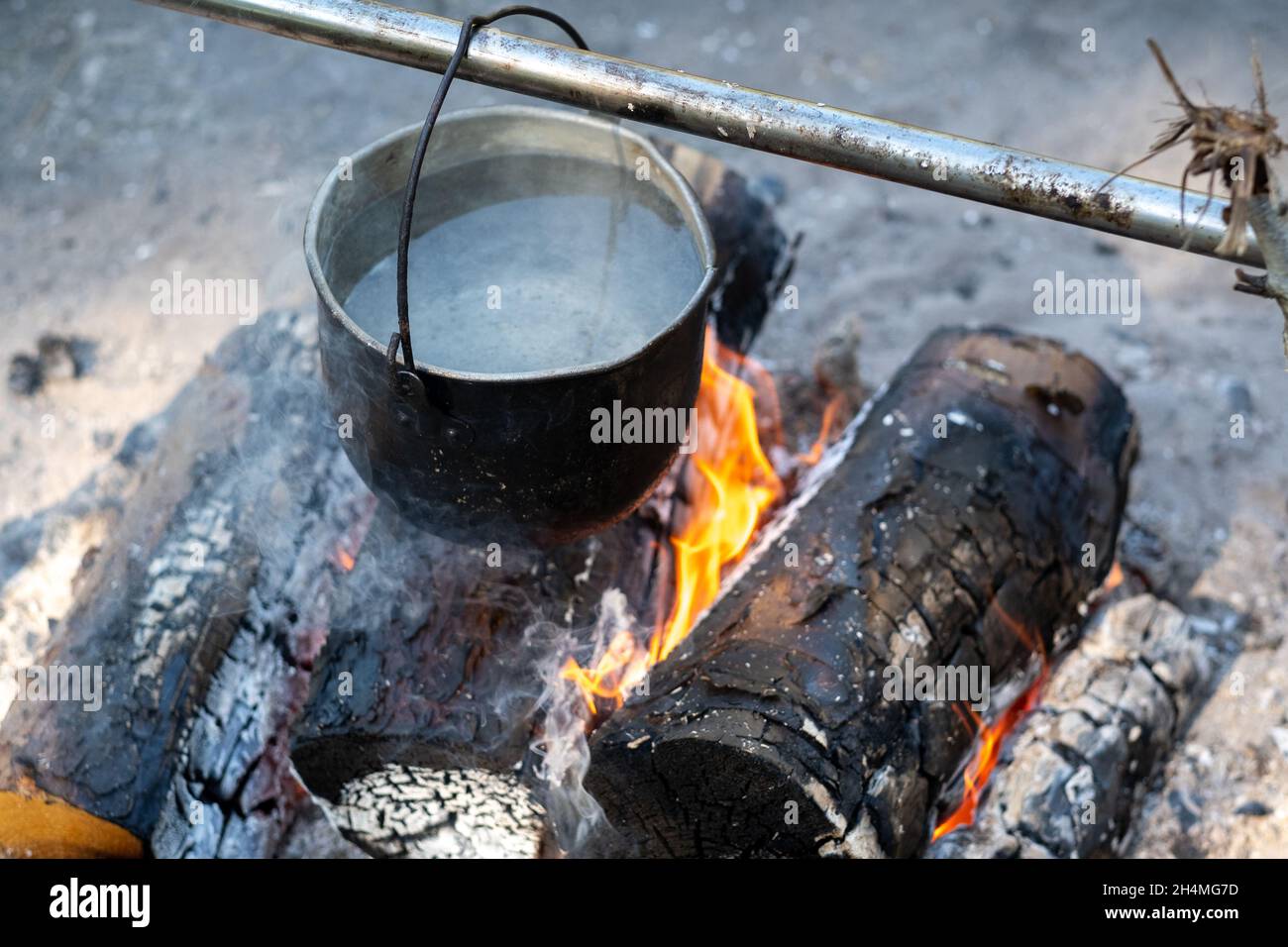 throw the ingredients into the soup which is cooked over a fire in a