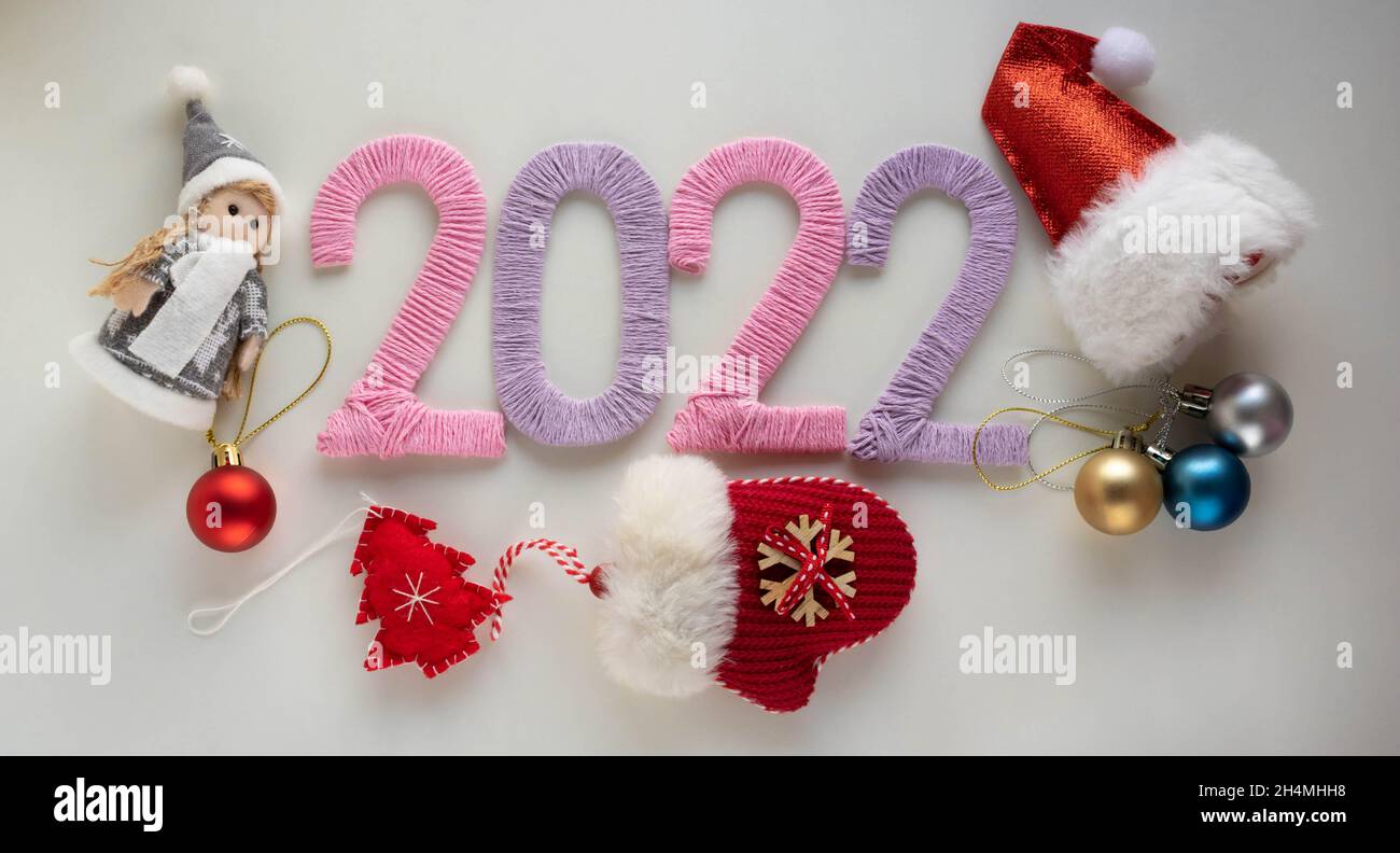 Free Toys For Christmas 2022 The Numbers 2022, Made With Pink And Lilac Threads On A White Background,  Are Next To Christmas Tree Toys. The Concept Of The New Year Stock Photo -  Alamy