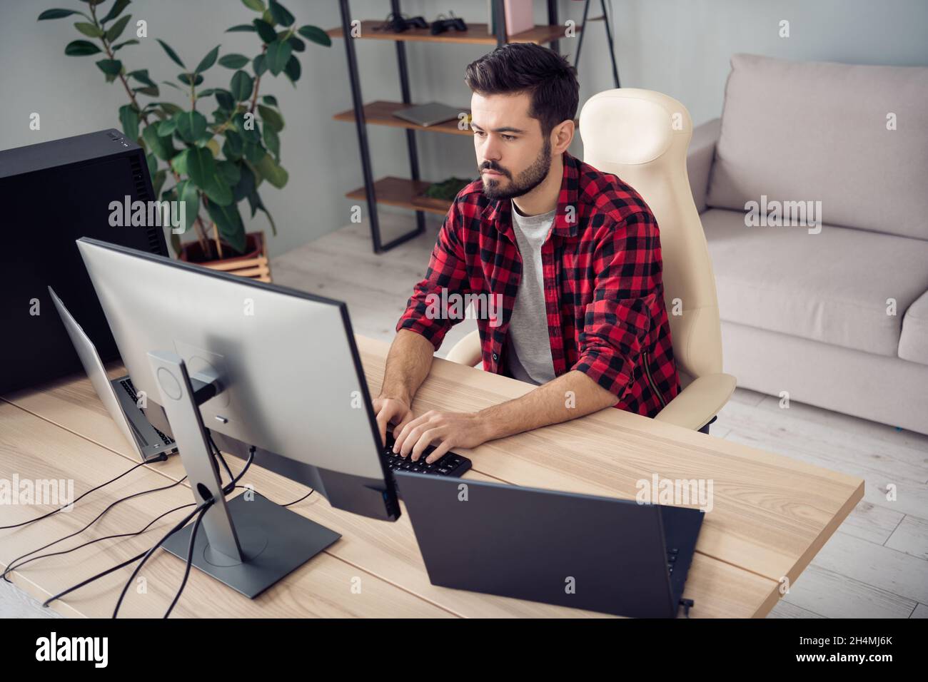 Photo of handsome young man programmer sit desk type code pc screen ...