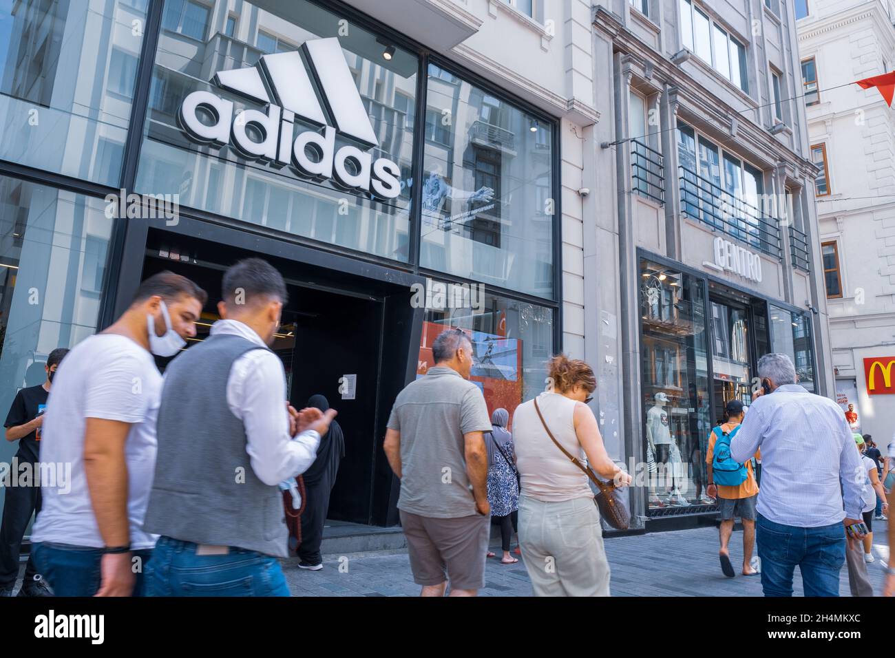 Beyoglu, Istanbul, Turkey - 08.03.2021: Adidas Turkish store in Taksim territory and some costumers buying clothes and others walking on Istiklal Inde Stock Photo