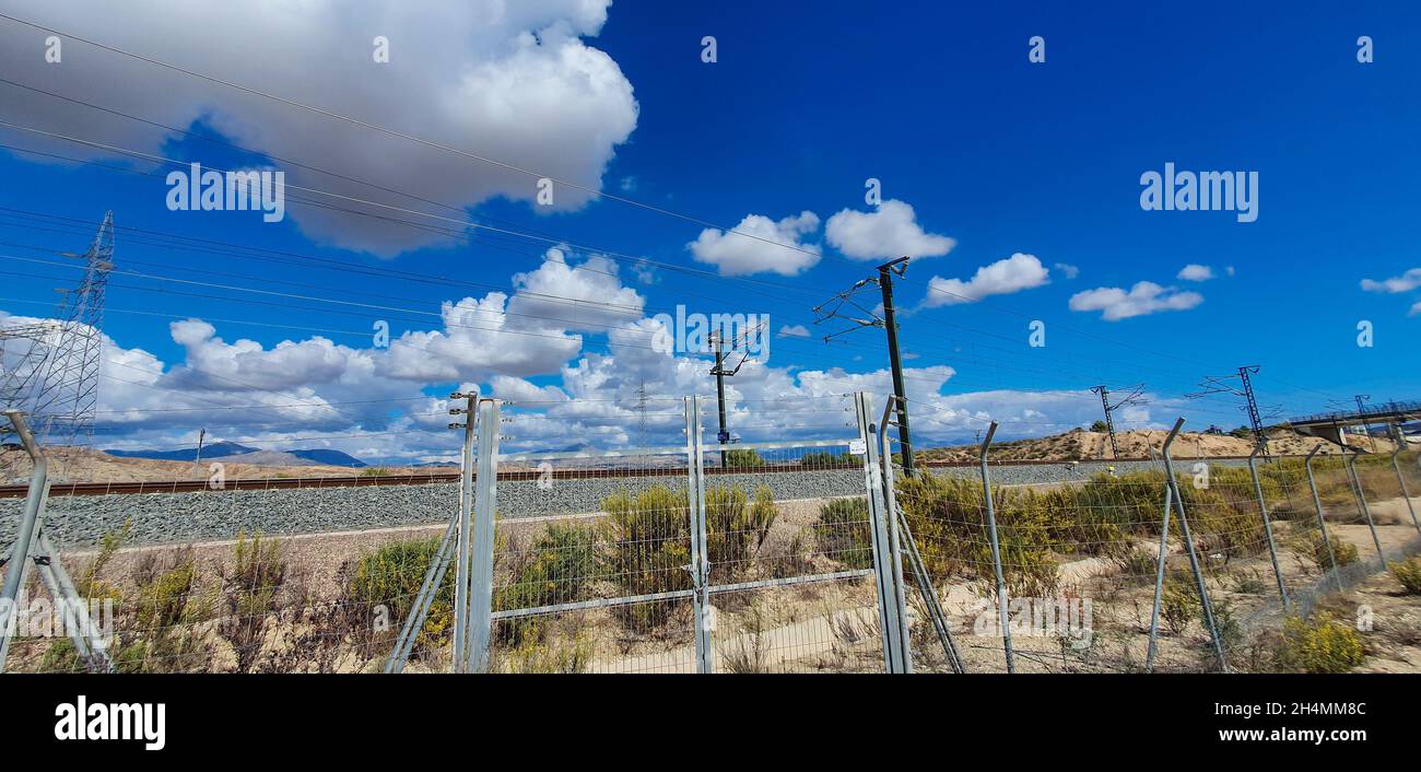 High voltage transmission towers under a blue sky with clouds Stock ...