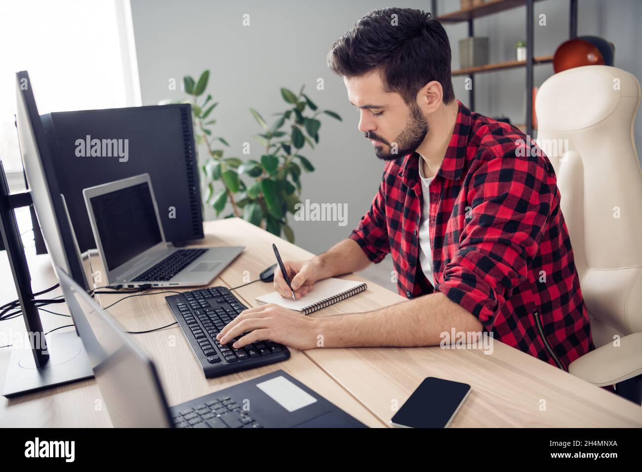 Profile side photo of young focused man write notebook computer ...