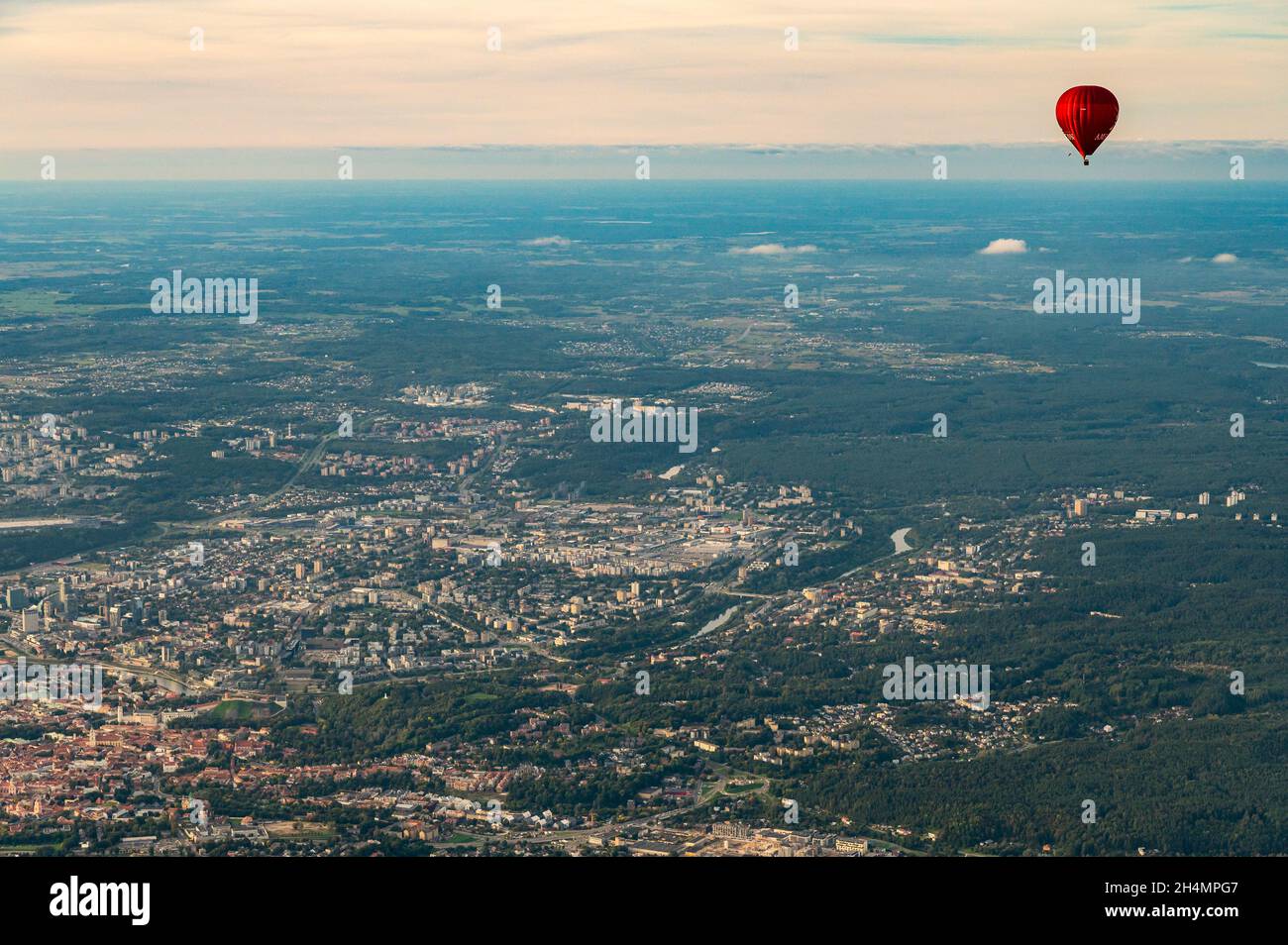 Vilnius, Lithuania - September 14, 2021: Red hot air balloon fly above Vilnius capital of Lithuania. Vilnius cityscape view from the sky Stock Photo