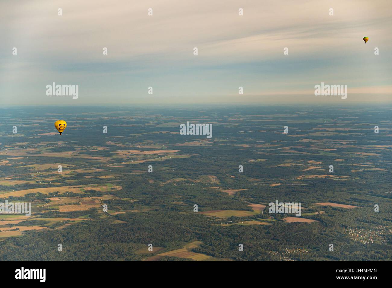 Vilnius, Lithuania - September 14, 2021: Vibrant hot air balloons fly above Vilnius surroundings in Lithuania. Vilnius county view from the sky Stock Photo