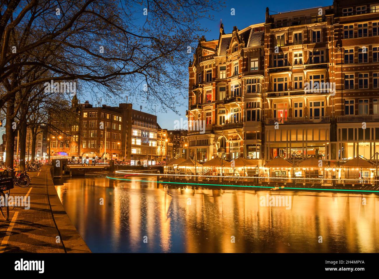 Amsterdam in twilight, night cityscape with buildings and river Stock Photo