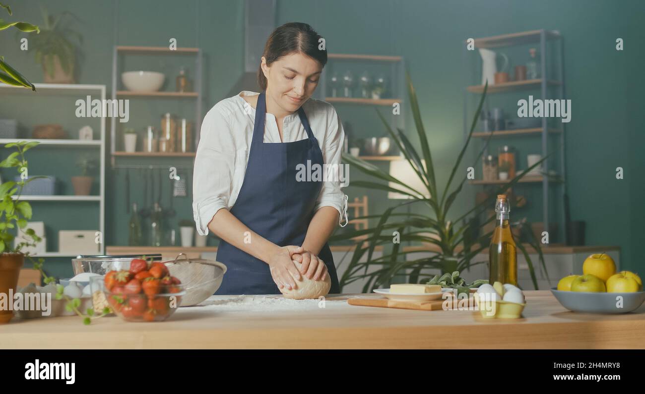 Professional Chef Sprinkles Flour and Kneads Dough on a Wooden Table ...