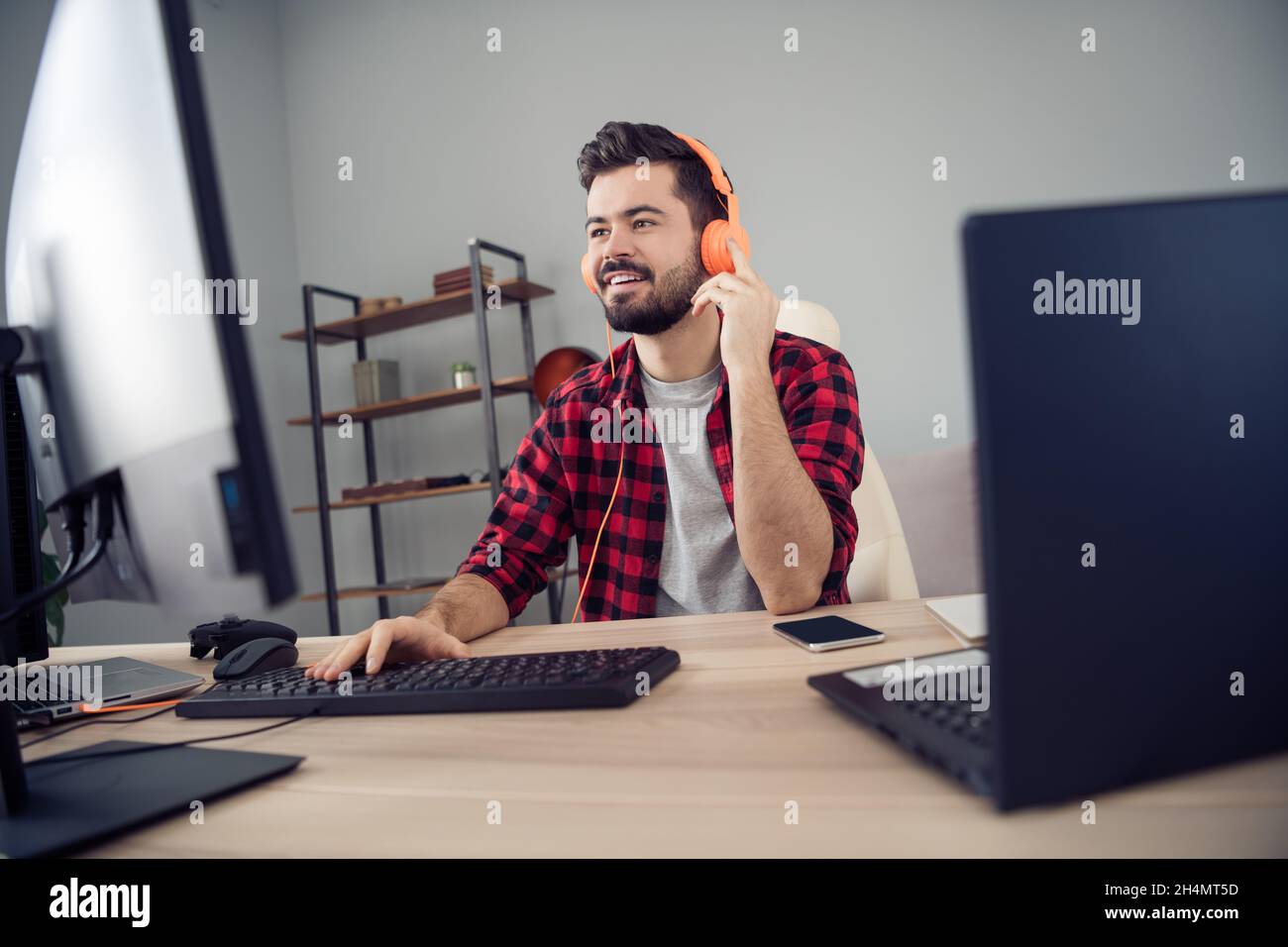 Portrait of attractive trendy cheery focused guy writing code e-mail script html at office workplace workstation indoor Stock Photo