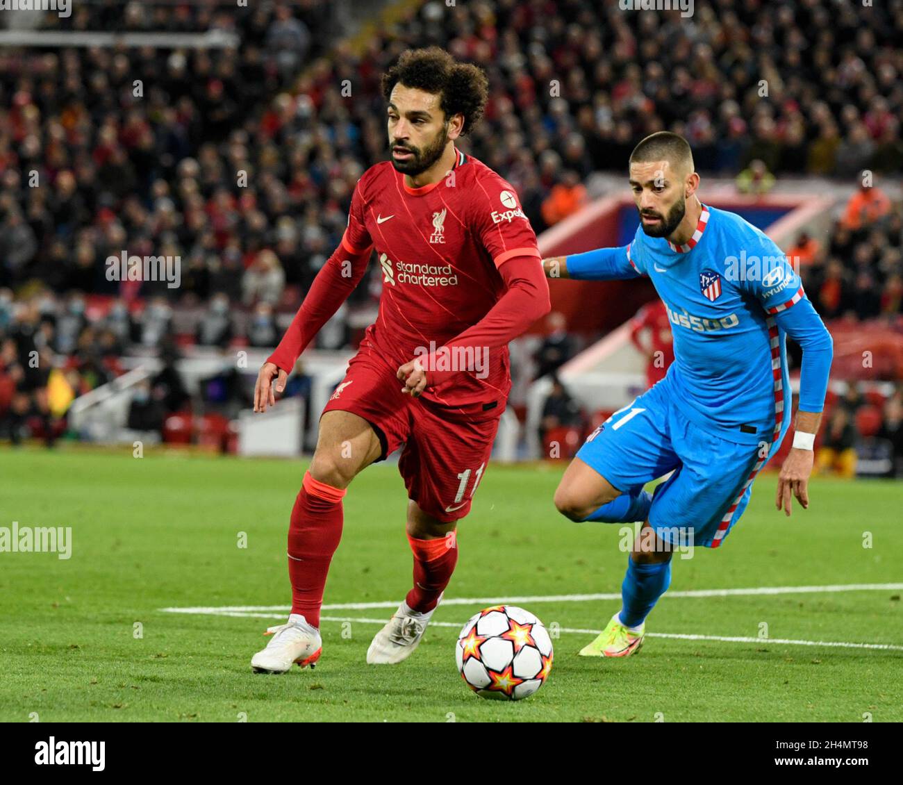 Mohamed Salah #11 of Liverpool shields the ball Yannick Carrasco #21 of Atletico Madrid Stock Photo