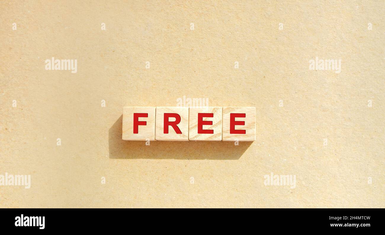 Wooden blocks with the word Free. Free courses, shipping, tax, trial version. Business and finance concept. Copy space Stock Photo
