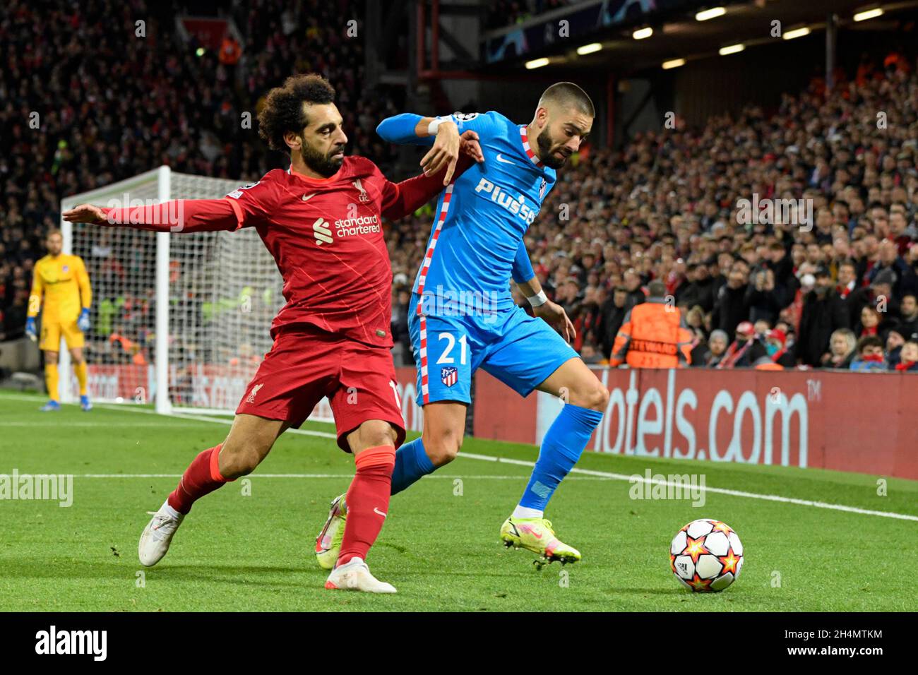 Mohamed Salah #11 of Liverpool challenges Yannick Carrasco #21 of Atletico Madrid for the ball Stock Photo